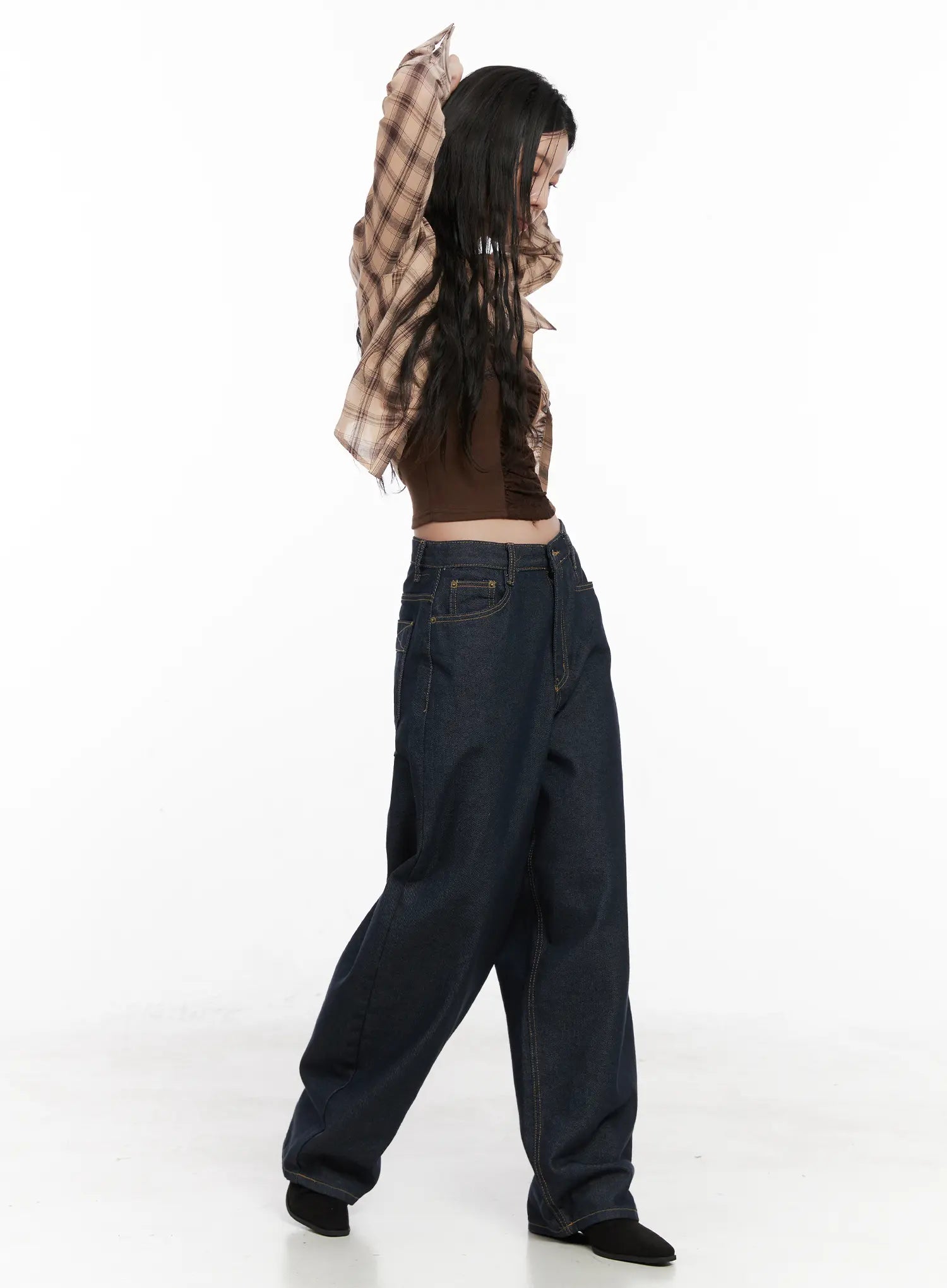 Heaven Wide-Leg Dark Washed Jeans CN513 in dark blue, side action shot on model mid-pose, side pocket and contrast stitch visible, styled with brown crop top.