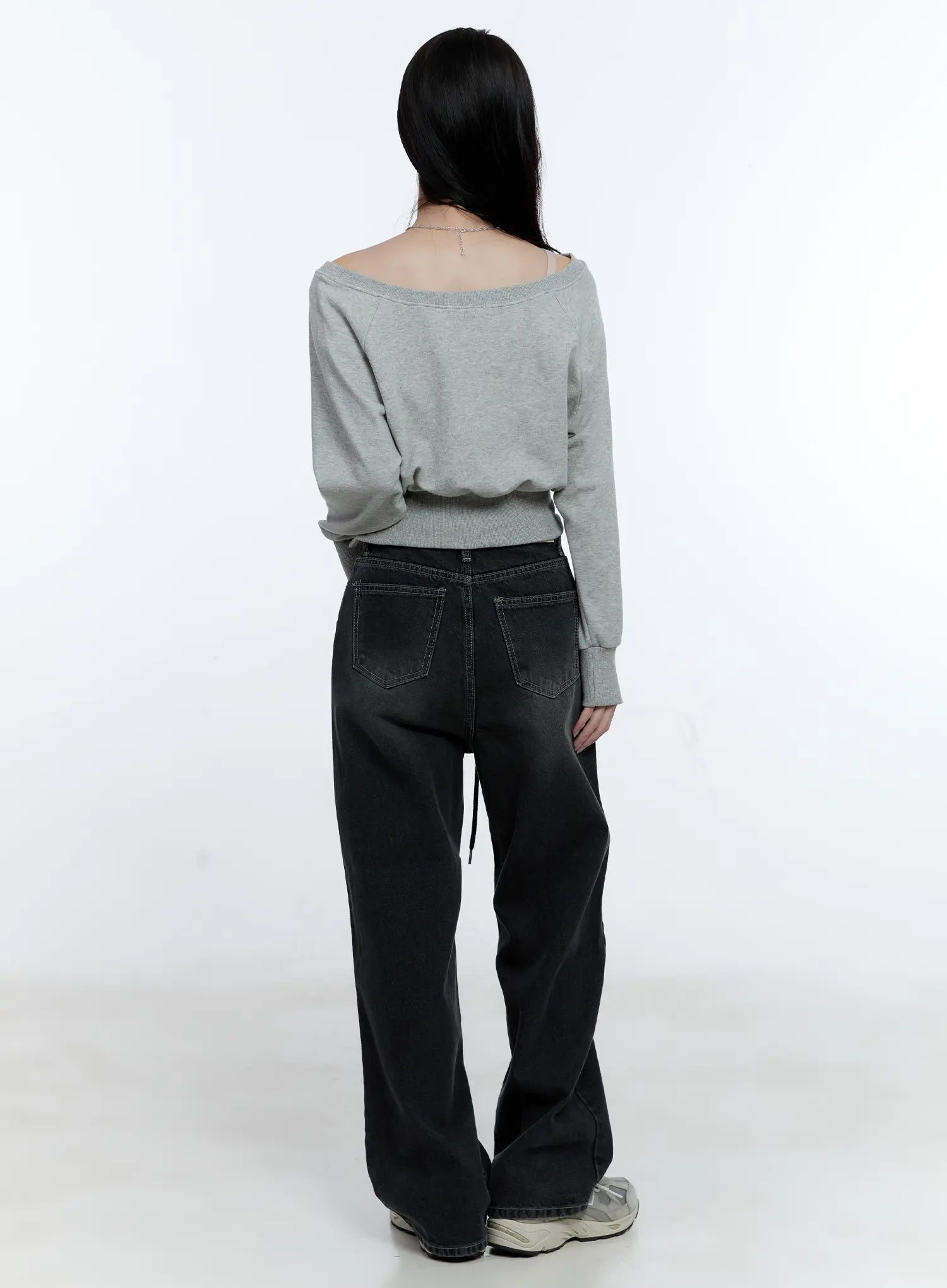 Lucinda High-Rise Wide Leg Jeans CG512 in black, back view on model, washed denim showing dual back pockets and drawstring detail, wide leg silhouette, styled with gray off-shoulder top and sneakers.