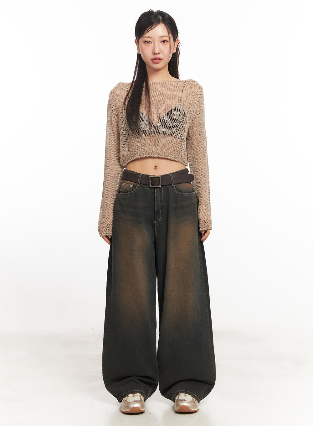 Bethany Vintage Washed Baggy Jeans IA524 in dark brown washed denim, straight-on front full-length view on model, wide baggy silhouette with vintage wash fade, brown belt, paired with beige open-knit crop top.