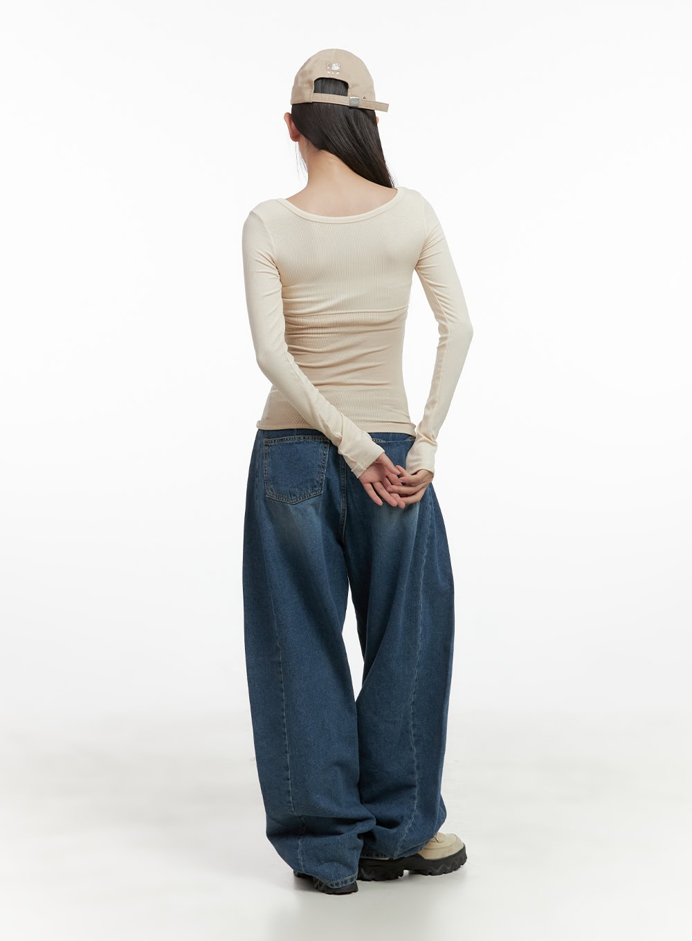 Lacey Washed Denim Baggy Jeans CO404 in blue, rear full-body shot on model, oversized wide-leg washed denim pooling at hem, styled with ribbed beige long-sleeve top.