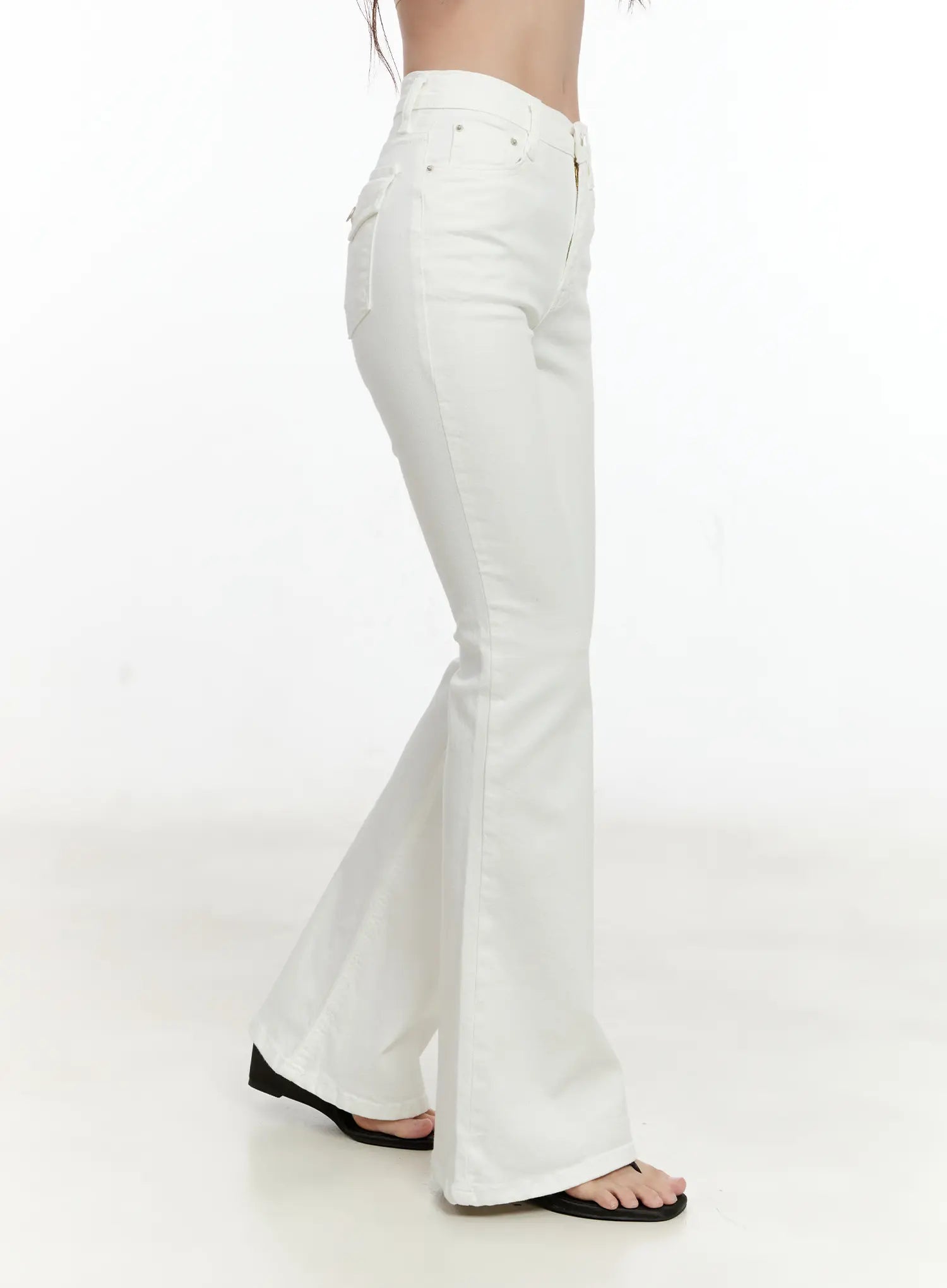 High-Waist Flare Pants CG501 in white, side view on model, showing slim thigh-to-knee fit and flared hem with cotton-spandex fabric, black sandals.