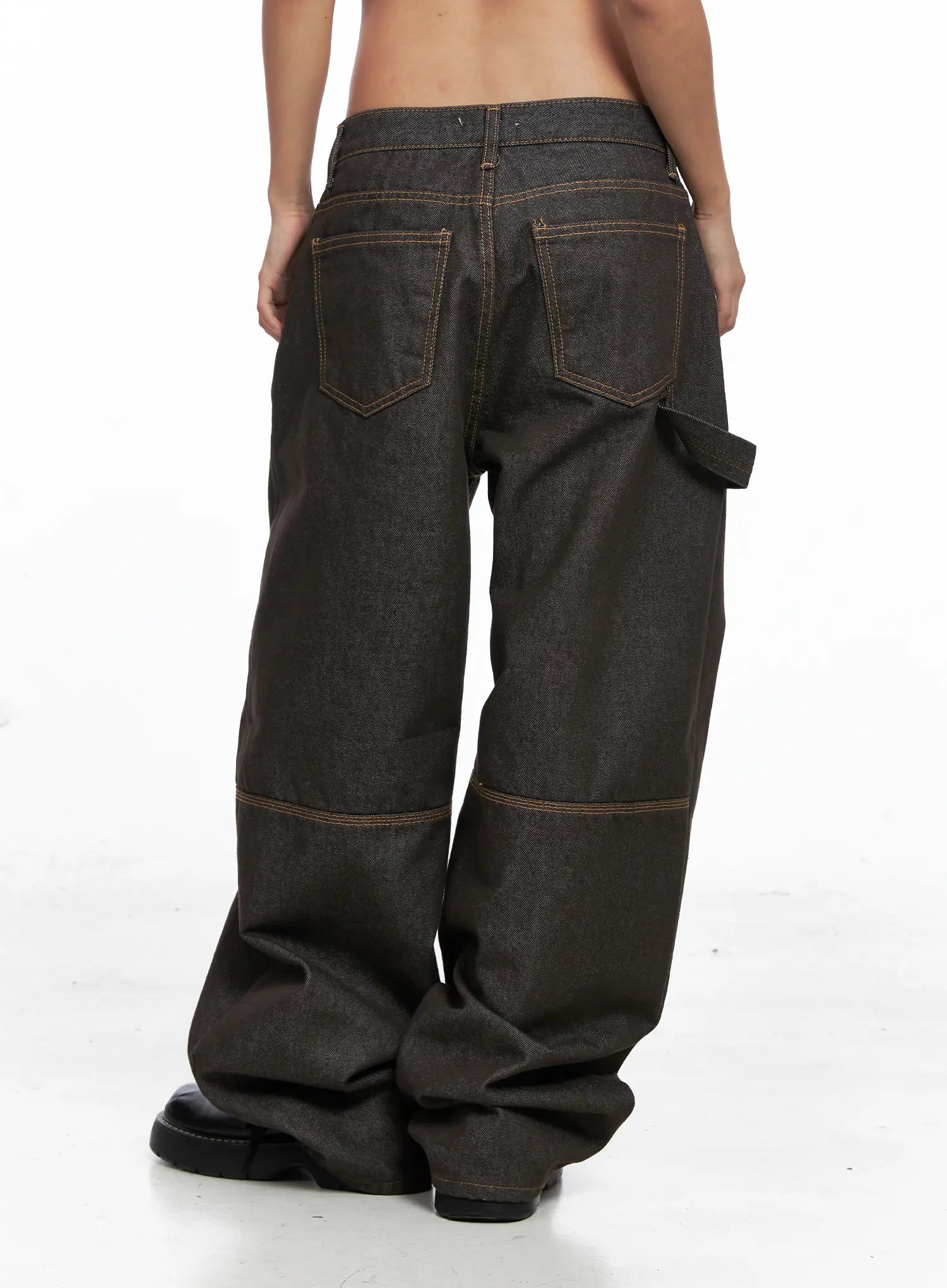 Oaklyn Non-Fade Wide-Leg Jeans CO513 in dark brown, back view on model, two back pockets with orange contrast topstitching, carpenter tab detail, wide-leg silhouette pooling at floor.
