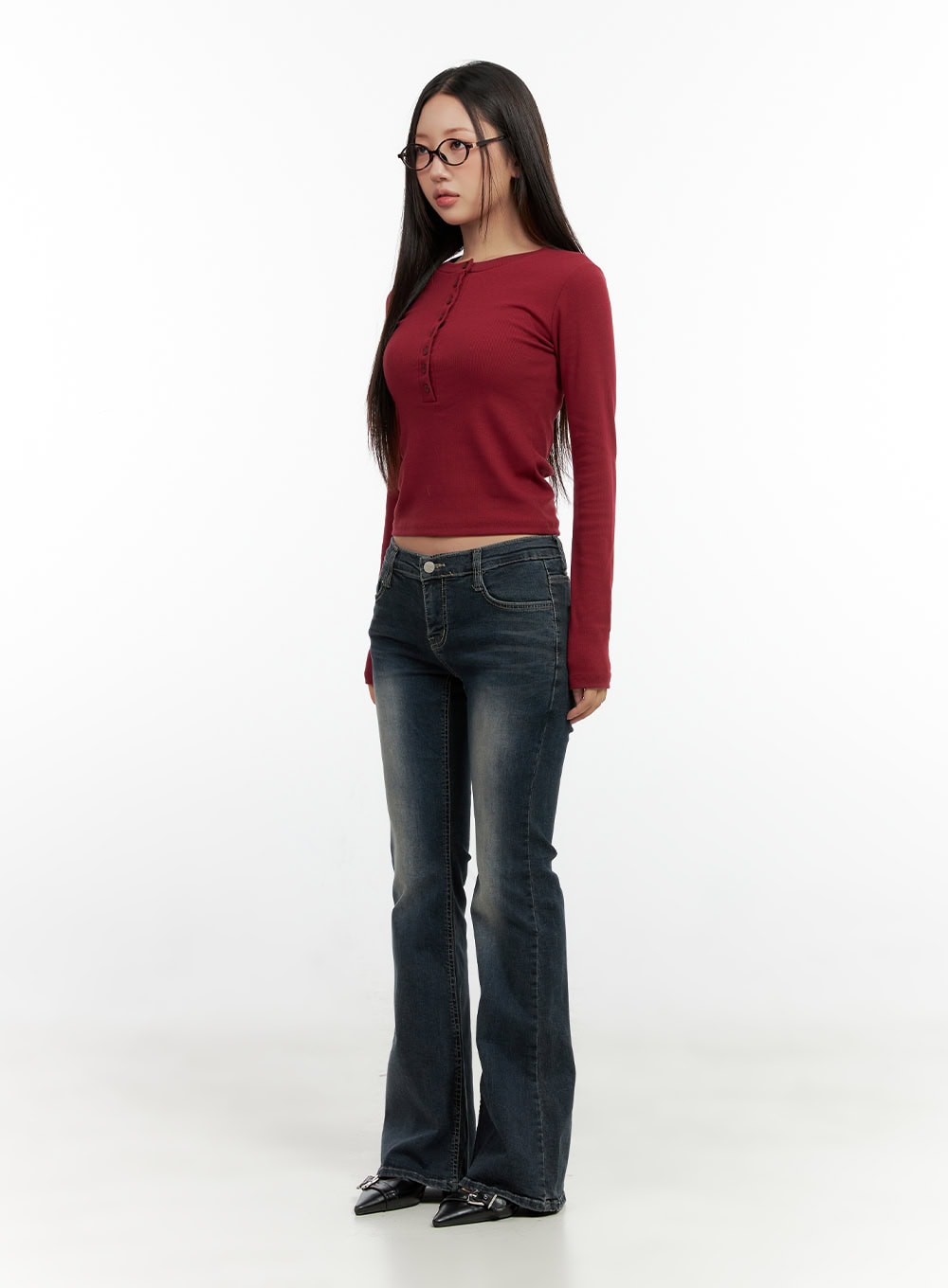 Ingrid Low-Rise Washed Flared Hip Pad Denim Jeans CN404 in dark blue, three-quarter angled full-body shot on model, low-rise waist and flared silhouette visible, styled with red ribbed crop top.