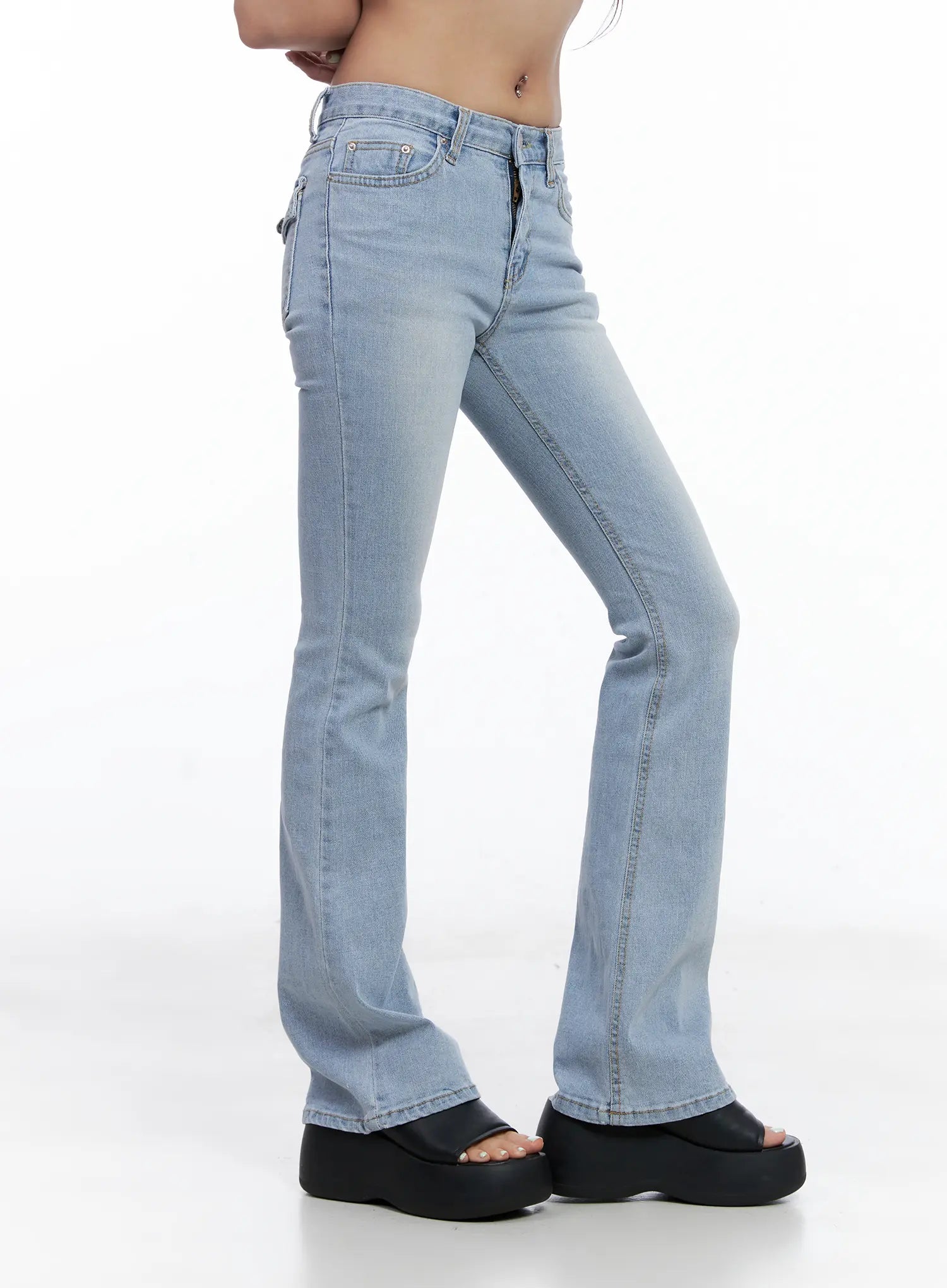Yeojin Classic Flare Denim Jeans CL510 in light blue, side view on model, washed bootcut silhouette showing flare hem and side seam detail, with black platform sandals.