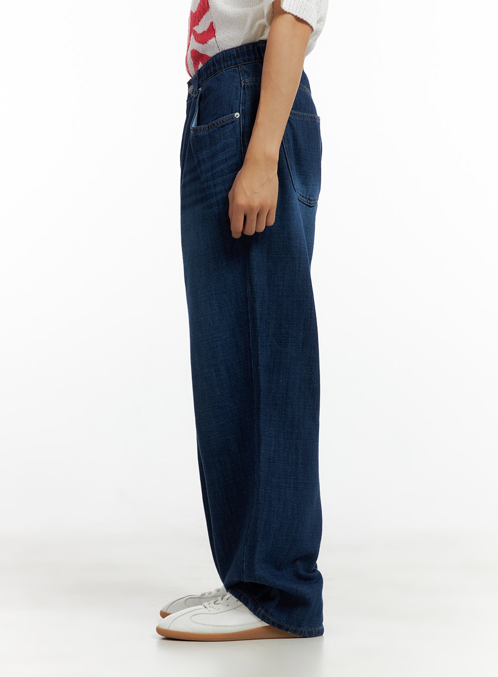 Men's Washed Cotton Denim Jeans CL429 in dark blue, side view on model, wide-leg straight silhouette, elastic waistband, washed cotton denim, paired with white sneakers.