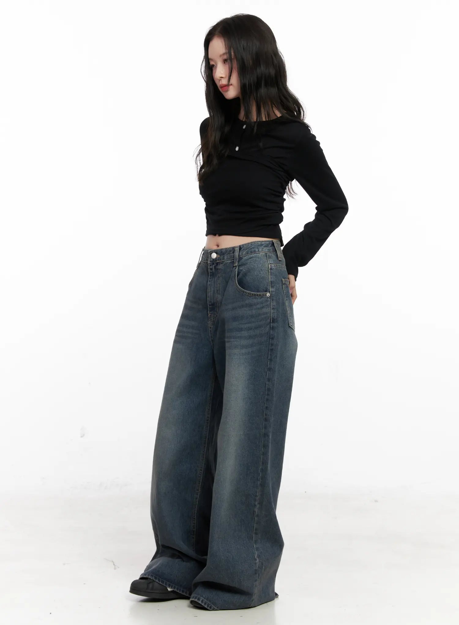 Tutt Washed Wide Leg Jeans CN504 in vintage blue, three-quarter side view on model looking down, back pocket and washed stitch detail visible, styled with black crop top.