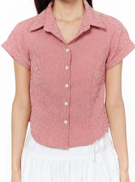 Gingham Button-Up Short Sleeve Blouse CU522 in red, front torso close-up on model, textured seersucker gingham, pearl button placket and point collar detail visible.