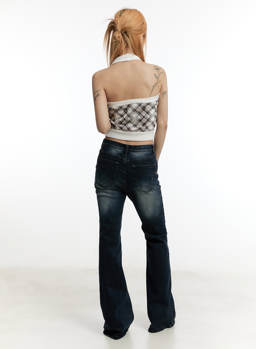 Ruelle Slim Washed Bootcut Jeans CY501 in dark blue, full back view on model, showing rear patch pockets with washed fading and wide bootcut hem, styled with plaid halter top.
