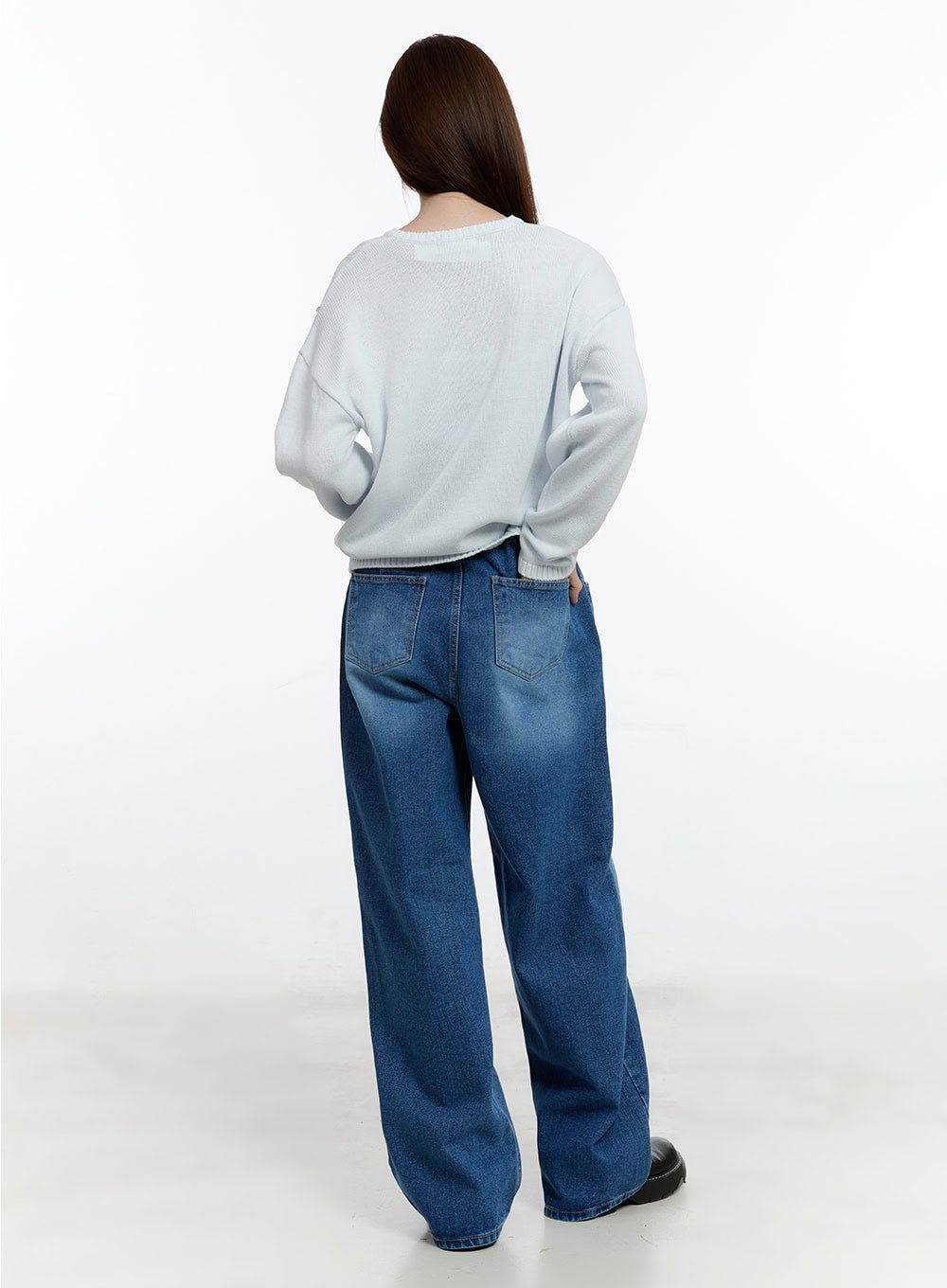 Eugene Adjustable Cinched-Back Wide-Leg Jeans CM521 in dark blue, full-body back view on model, wide-leg washed denim showing back pockets, styled with white knit sweater and black platform shoes.
