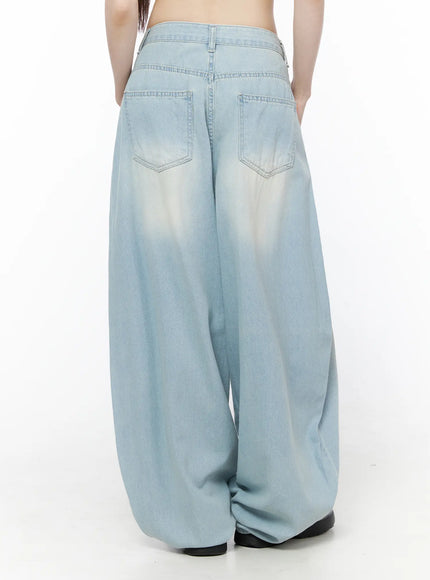 Ozzy Washed Wide Leg Jeans CU519 in light blue, back view on model, dual patch pockets with visible stitching, faded wash across seat and wide ballooned legs.