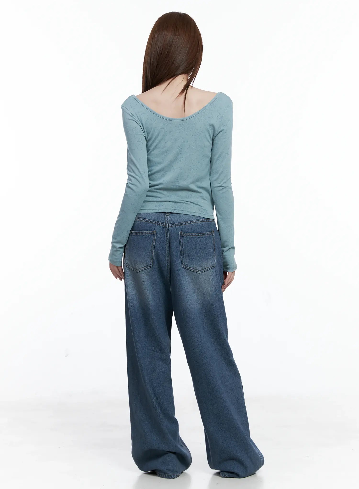 Margot Low-Rise Washed Wide-Leg Jeans CS501 in dark blue, back view on model showing rear pockets and washed fading, styled with teal long-sleeve top.