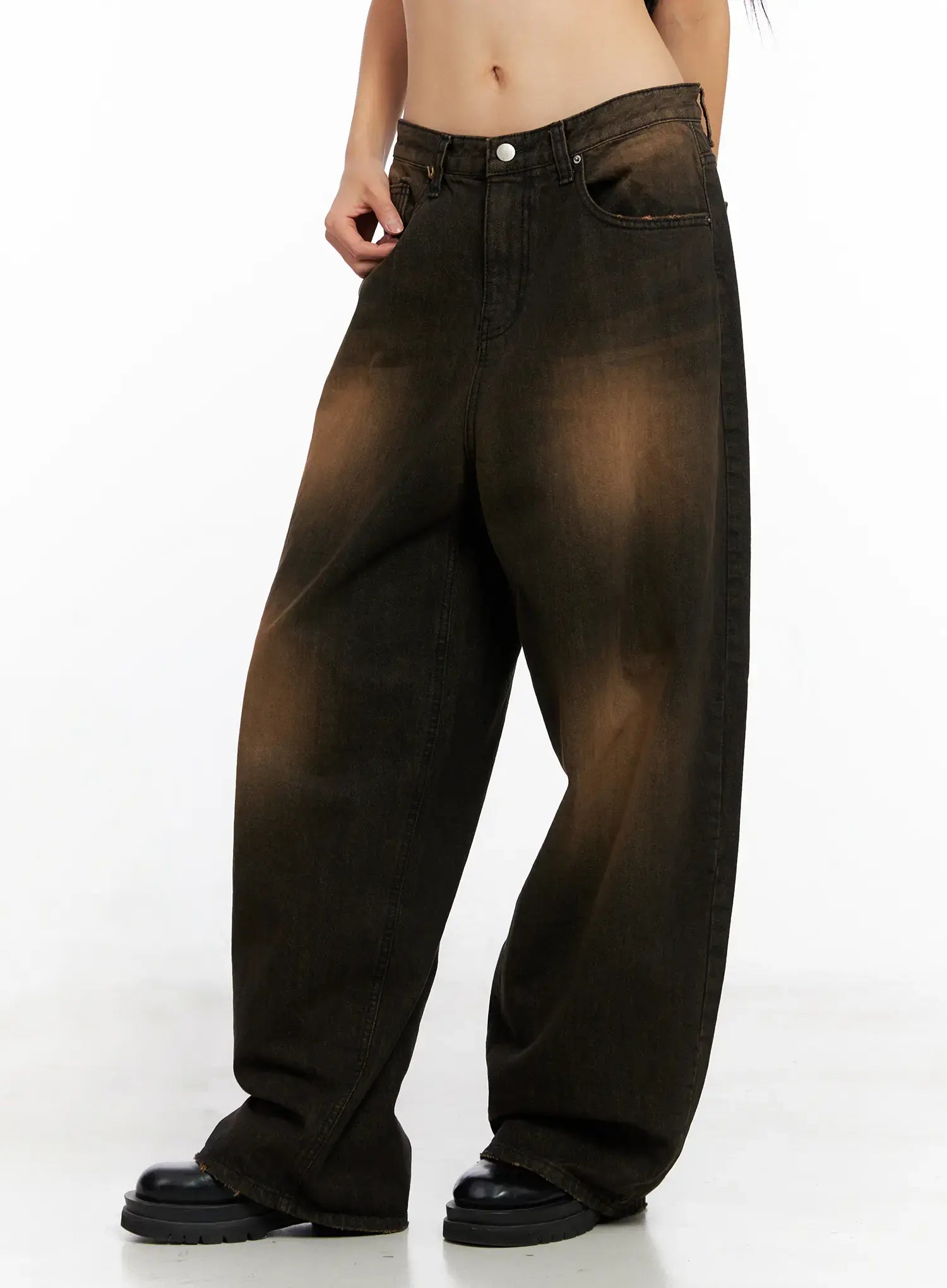 Analia Washed Wide-Leg Jeans CO529 in brown, side-front view on model, showing wide-leg silhouette with raw hem edge and amber washed fading down the leg.