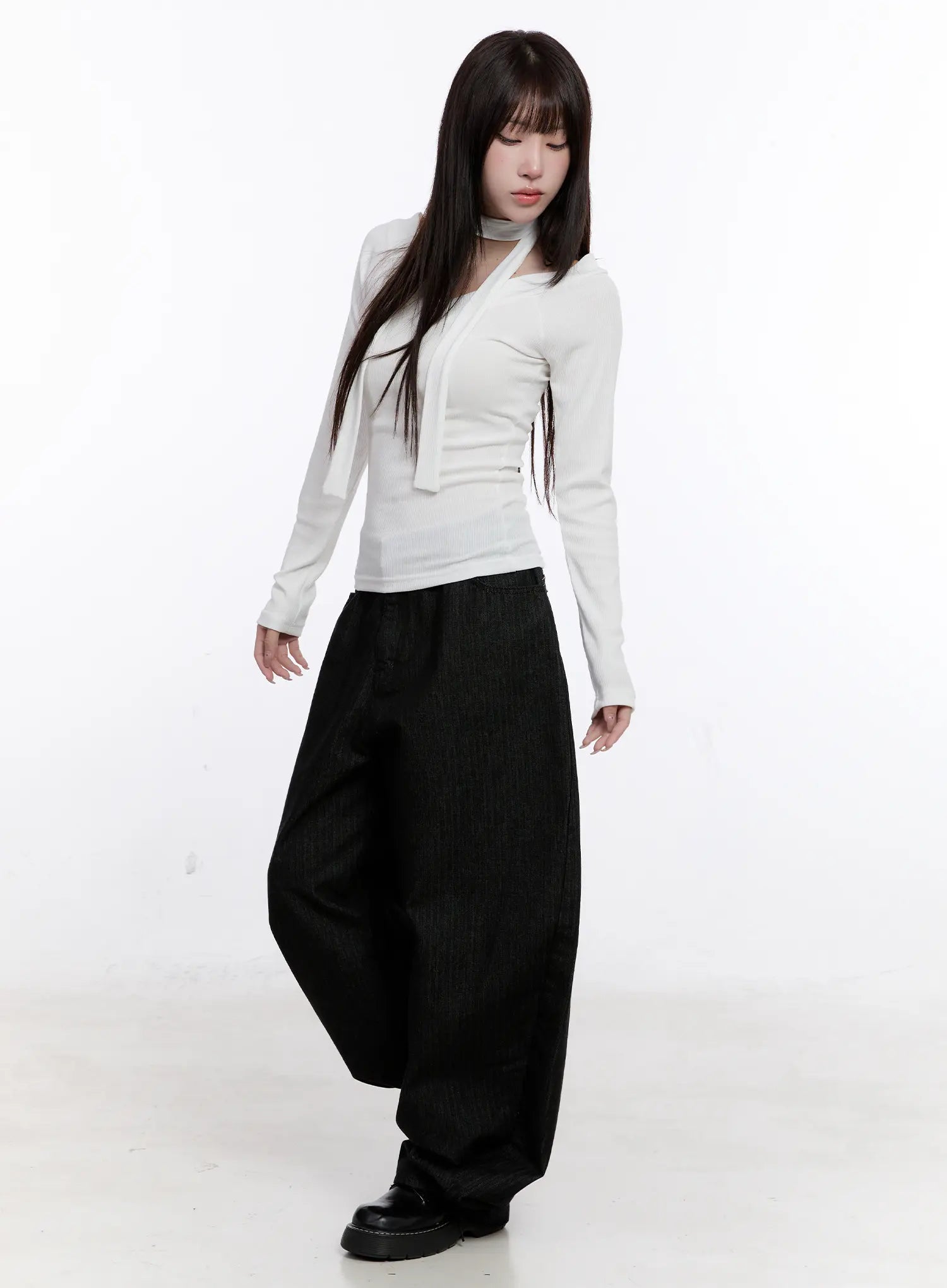 Vada Stitched Wide Leg Jeans CS530 in Black, three-quarter front styled shot on model, floor-length wide-leg cotton denim worn with white fitted long-sleeve top and black platform shoes.