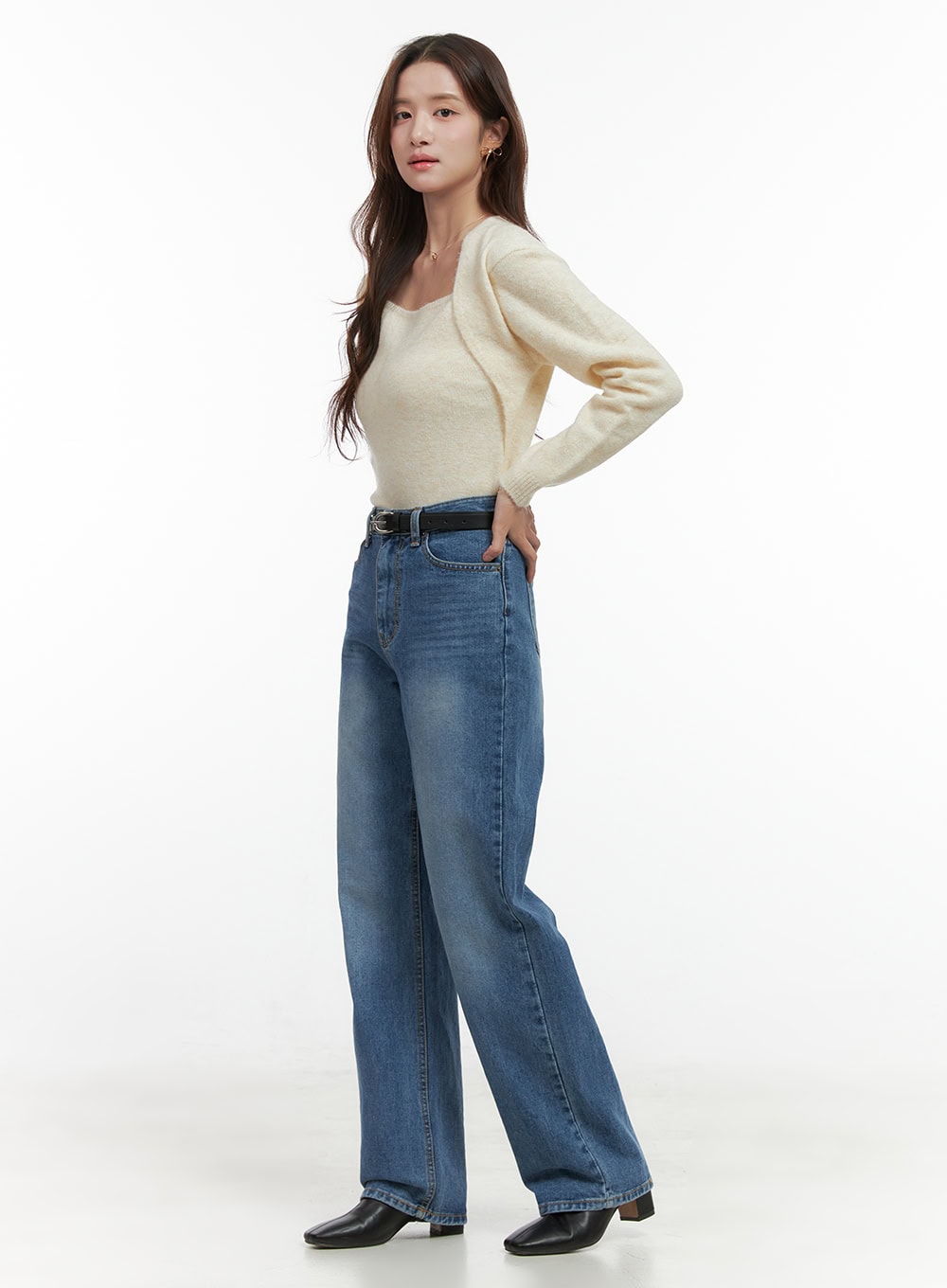 Evelyn Wide-Fit Straight Denim Jeans OO421 in Blue, side view on model, high-rise washed denim, wide straight leg silhouette, hand on hip, styled with cream knit and black belt.