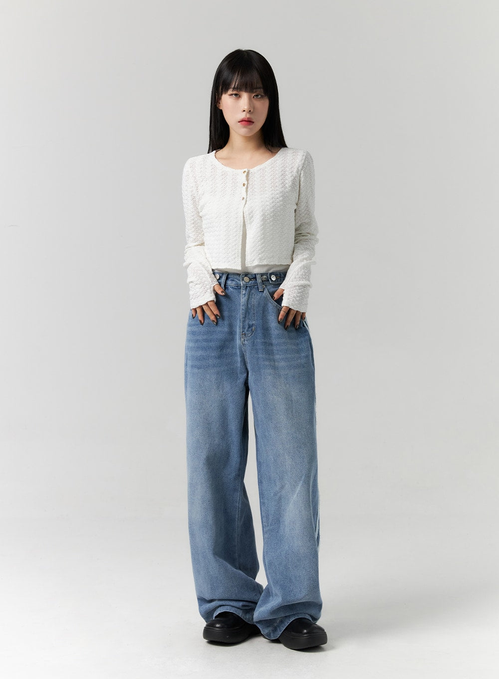 Side Stripes Wide Leg Jeans CS314 in blue, full-length front view on model hands in pockets, high-waist washed denim, floor-grazing wide leg, paired with white textured cardigan.