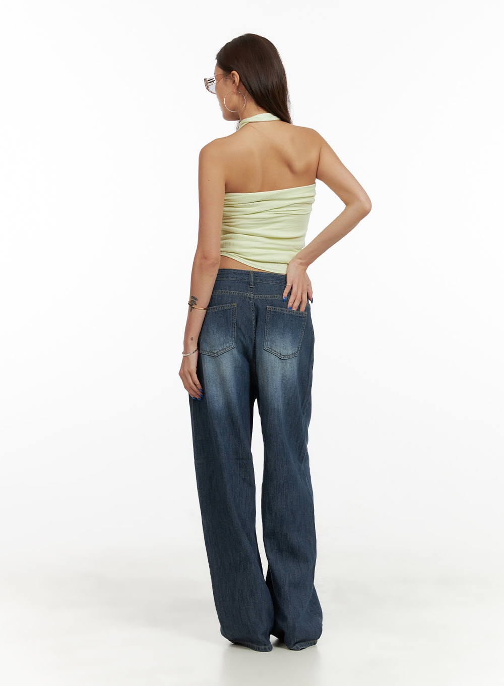 Low Rise Wide Fit Baggy Jeans CY431 in dark blue, full-body back view on model, washed denim with dual back patch pockets and wide baggy leg, paired with lime halter top and black flats.