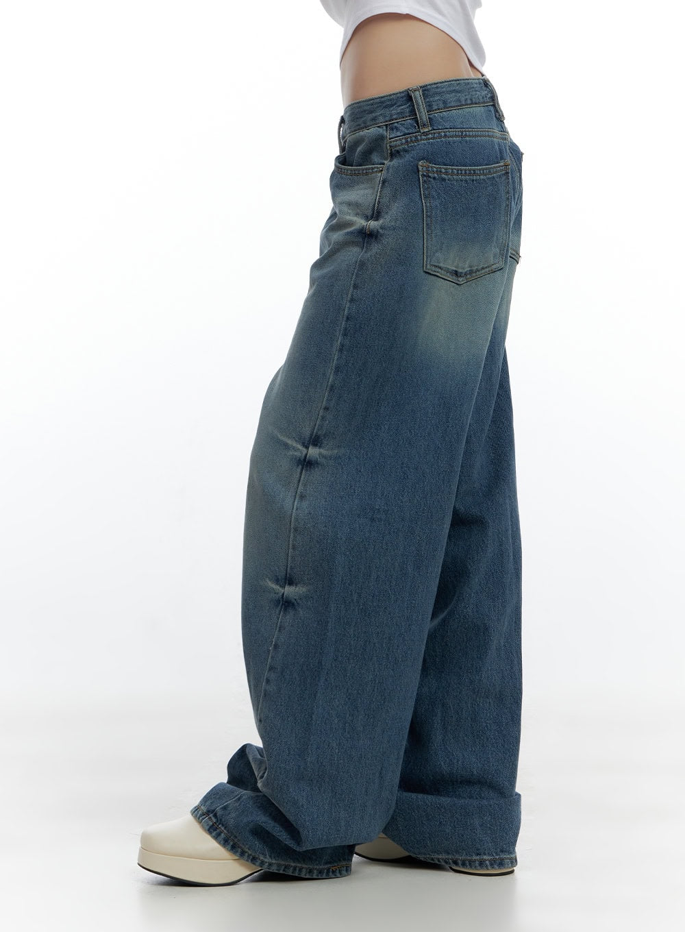 Aria Comfy Cotton Wide Leg Jeans CS420 in blue, side-back view on model, back pocket and low-rise waistband visible, wide baggy leg with washed vintage denim, paired with white crop top.