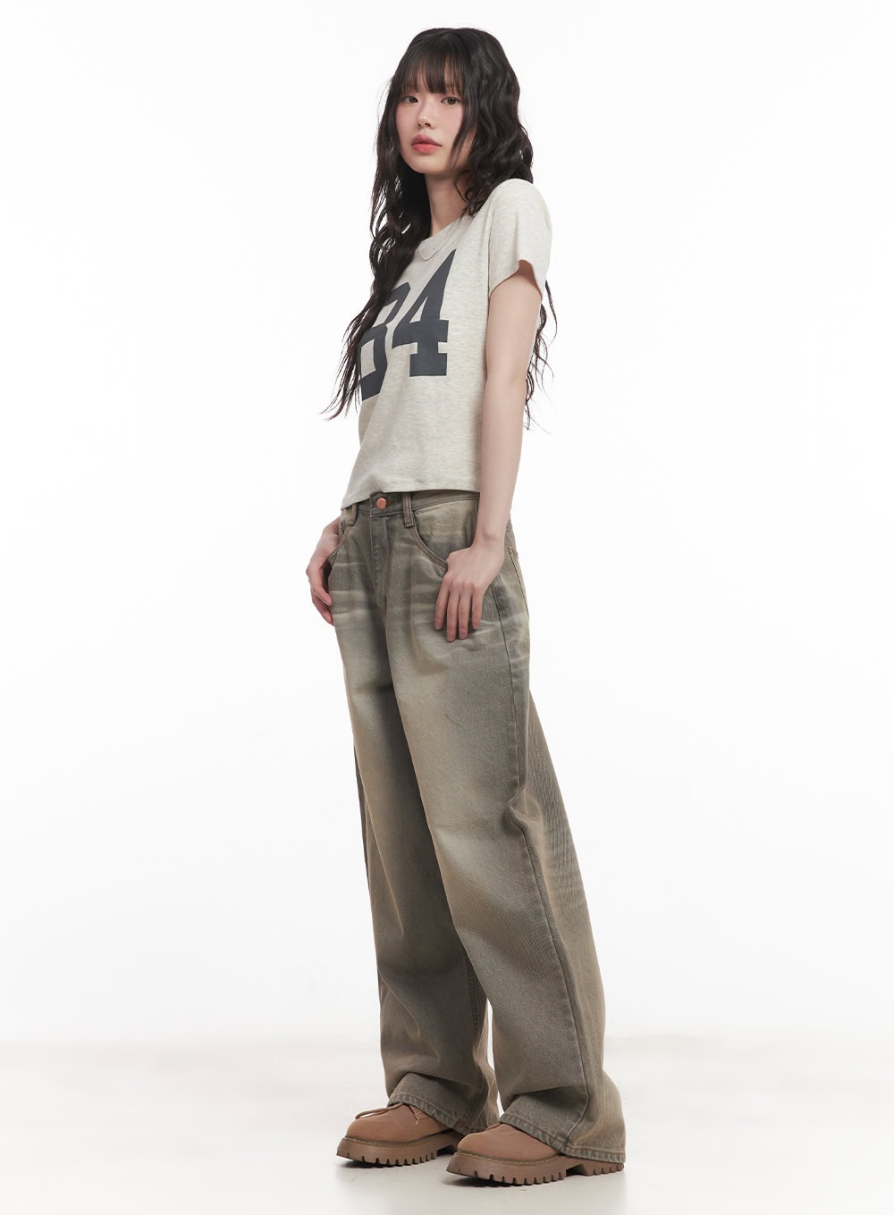 Joey Washed Wide-Leg Jeans CM528 in gray, side-angle full-body shot on model, showcasing wide-leg silhouette and washed denim drape, styled with a cropped graphic tee and brown lug-sole shoes.