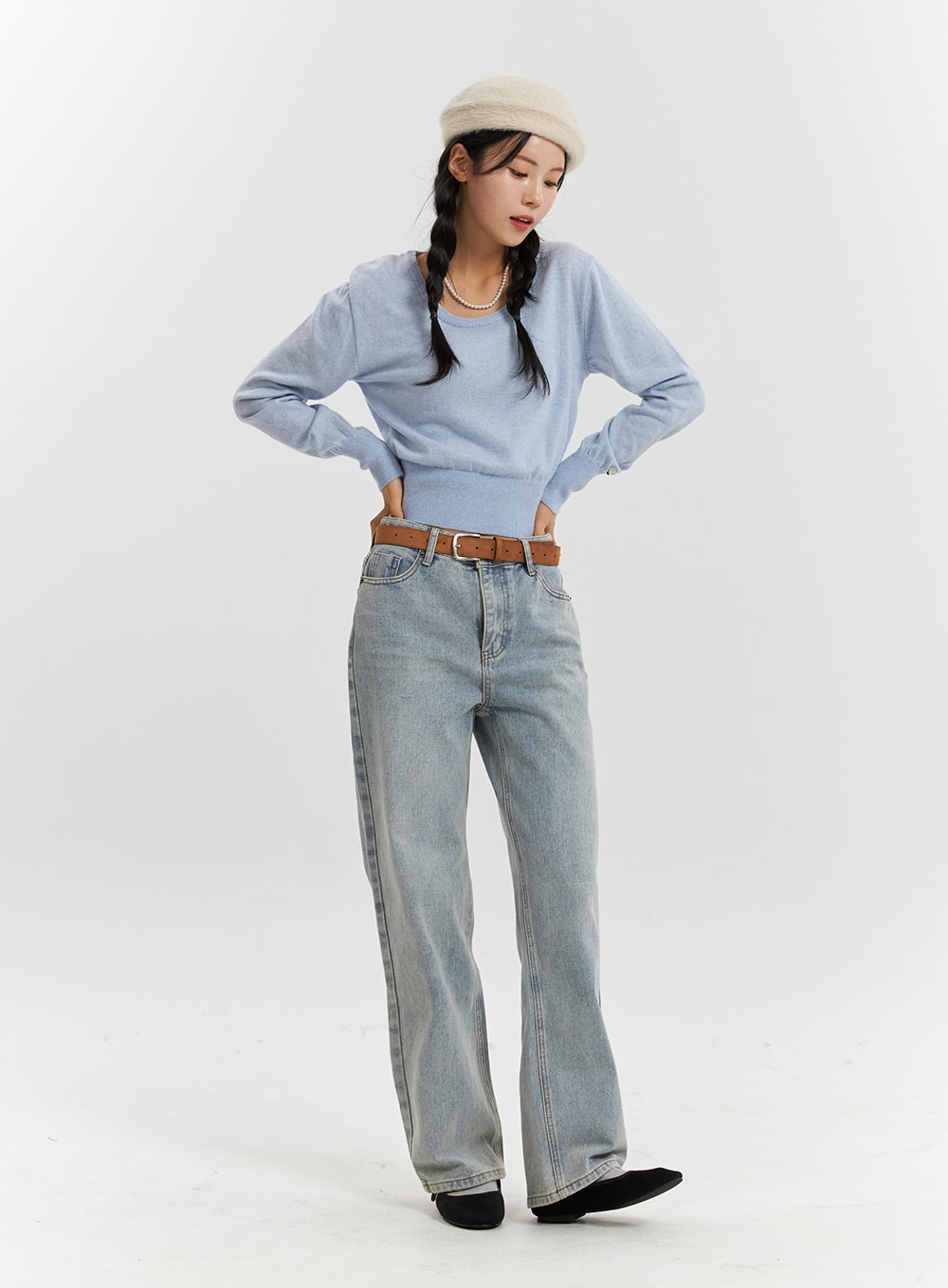 High-Waisted Full-Length Straight Leg Jeans OD320 in light blue, full-body front shot on model looking down, washed straight-leg denim, high waist with tan belt and crop knit top.