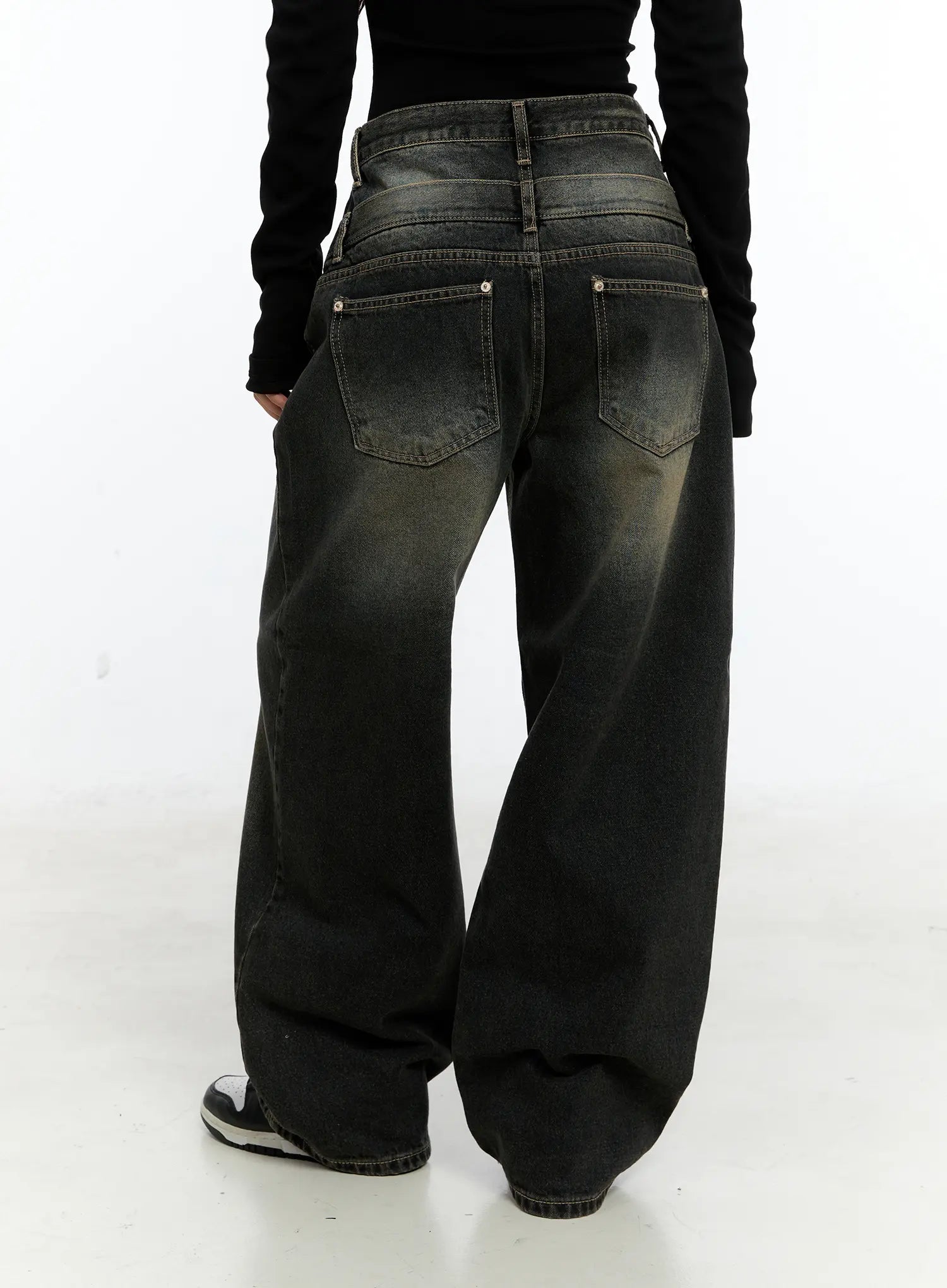 Emerie Washed Wide-Leg Baggy Jeans CS518 in dark blue, back view on model, featuring dual back patch pockets with rivet hardware and washed fading across seat and leg, paired with black top.