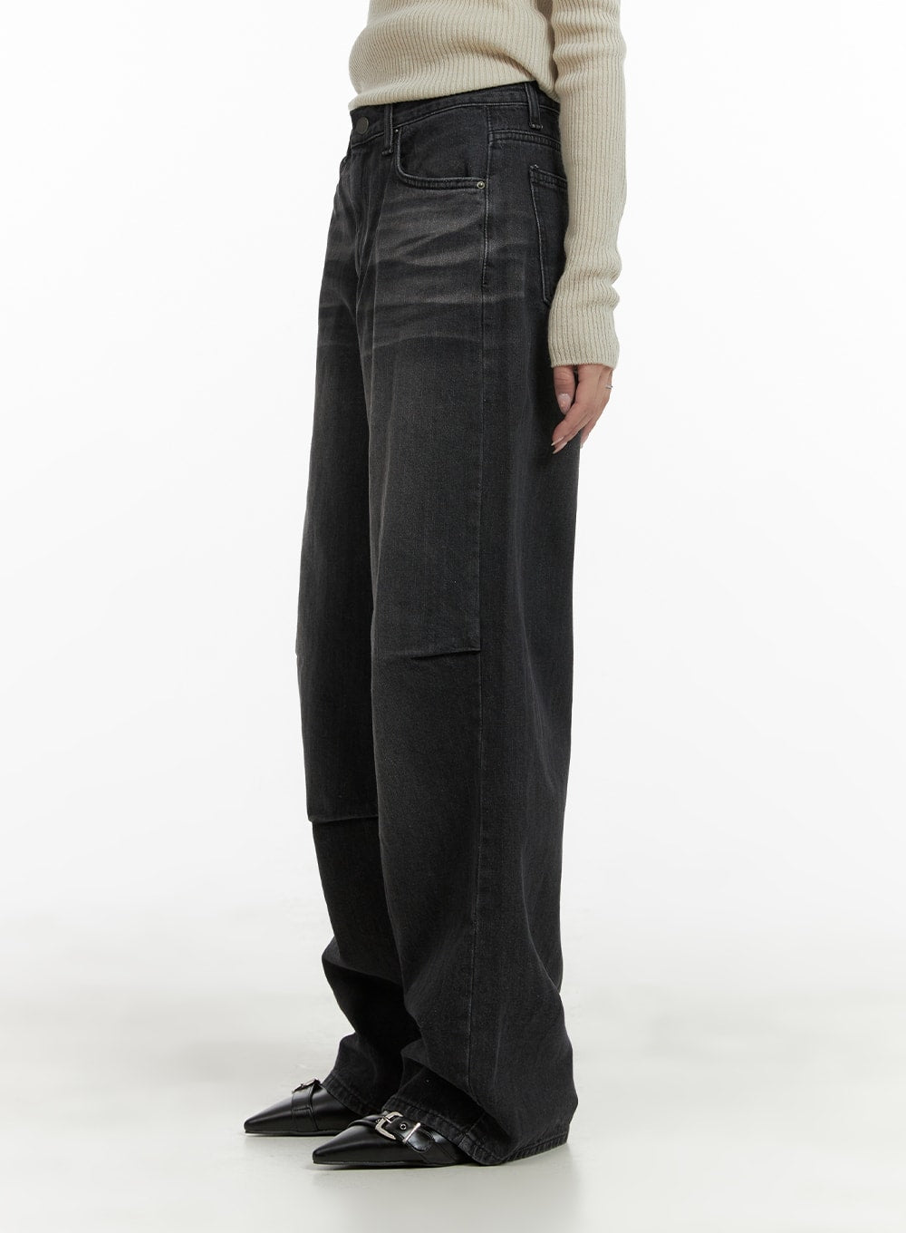 Pintuck Washed Wide Leg Jeans CA403 in Black, side view on model, pintuck seam detail visible along thigh, floor-grazing wide leg length, paired with cream ribbed knit and black buckle flats.