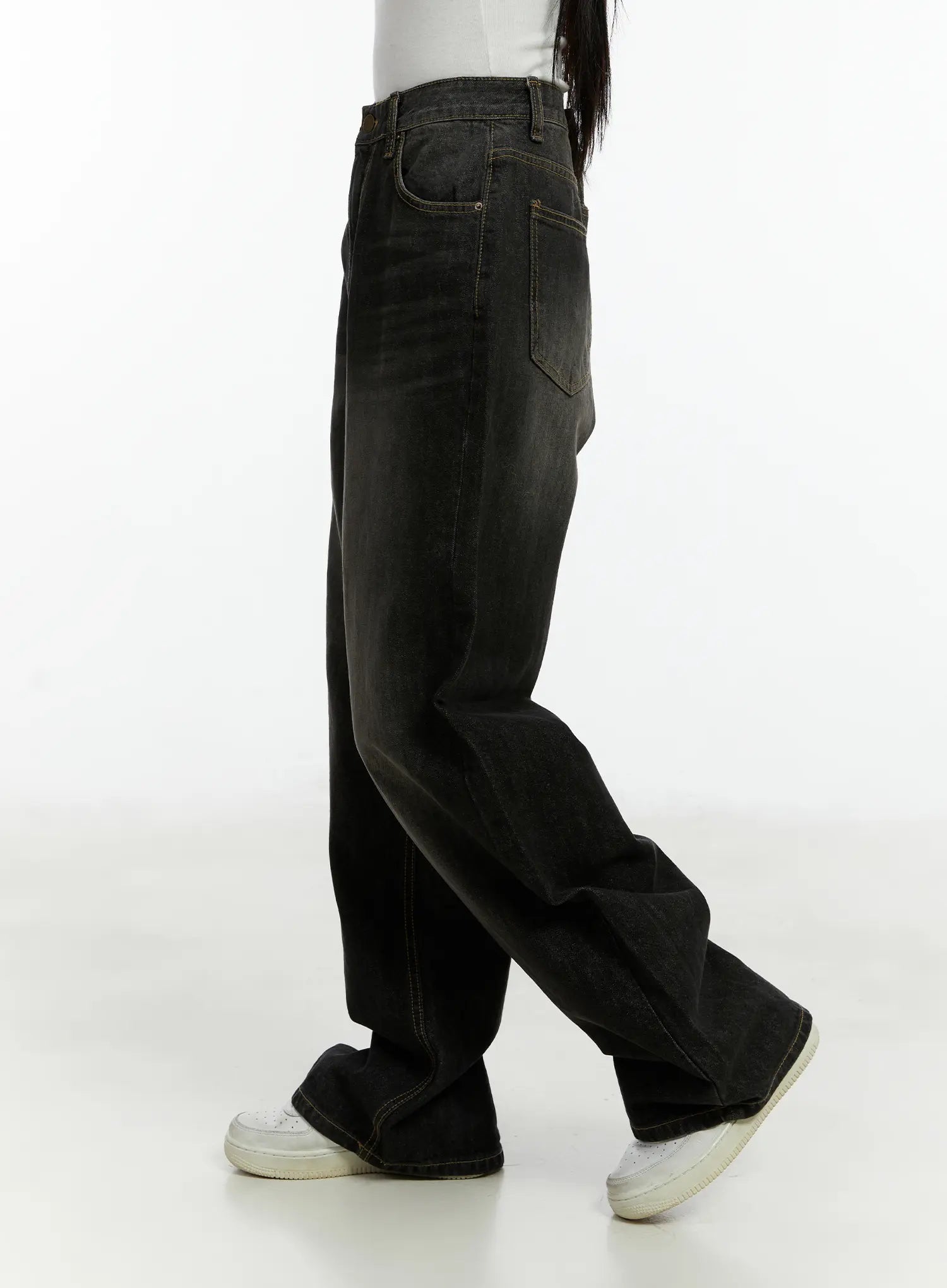 Haze Washed Wide-Leg Jeans CD523 in black, side view on model mid-stride, showing deep wide leg, back pocket, contrast stitching, and washed gradient fade.