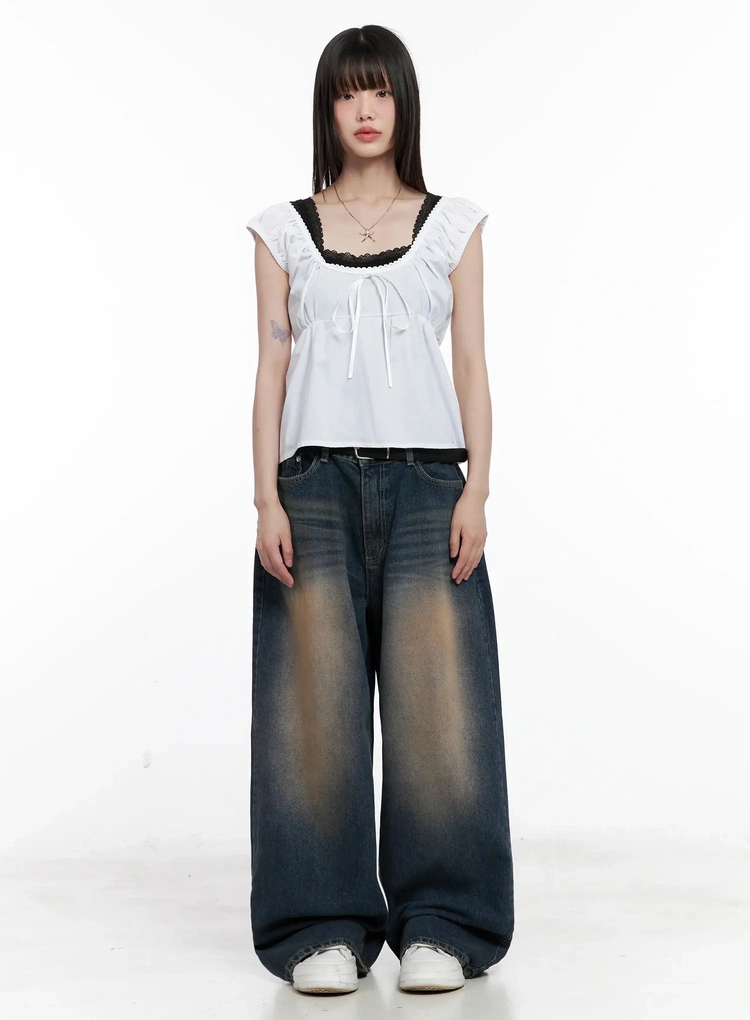 Solji Acid Washed Wide-Leg Jeans IL531 in dark blue, full-body front shot on model, arms at sides, styled with white lace-trim ruffle top and belt, floor-length wide leg.