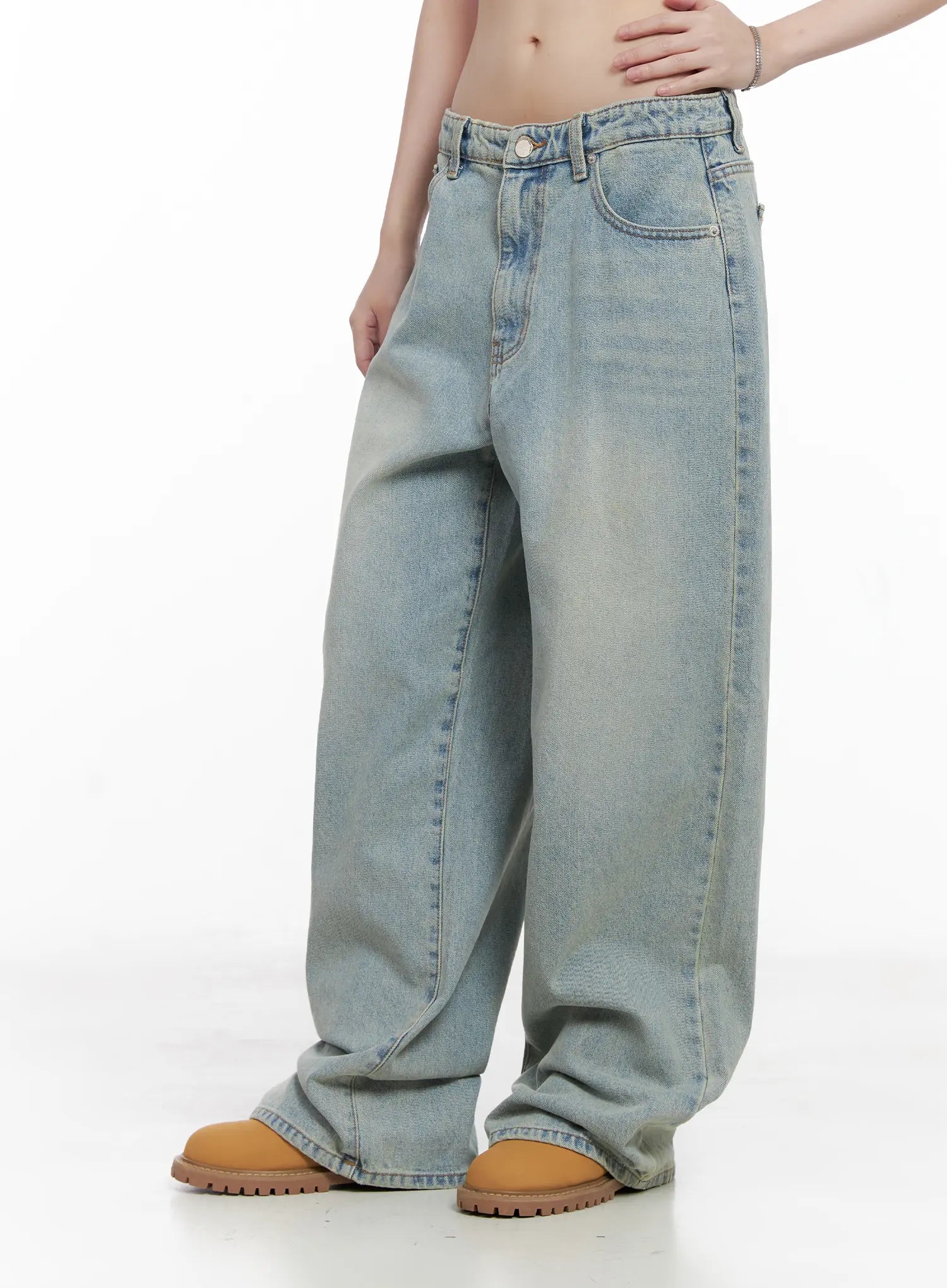 Lilly Light Wash Baggy Jeans CG519 in light blue, side view from waist to hem on model, wide-leg silhouette with faded wash and floor-grazing length, paired with tan boots.