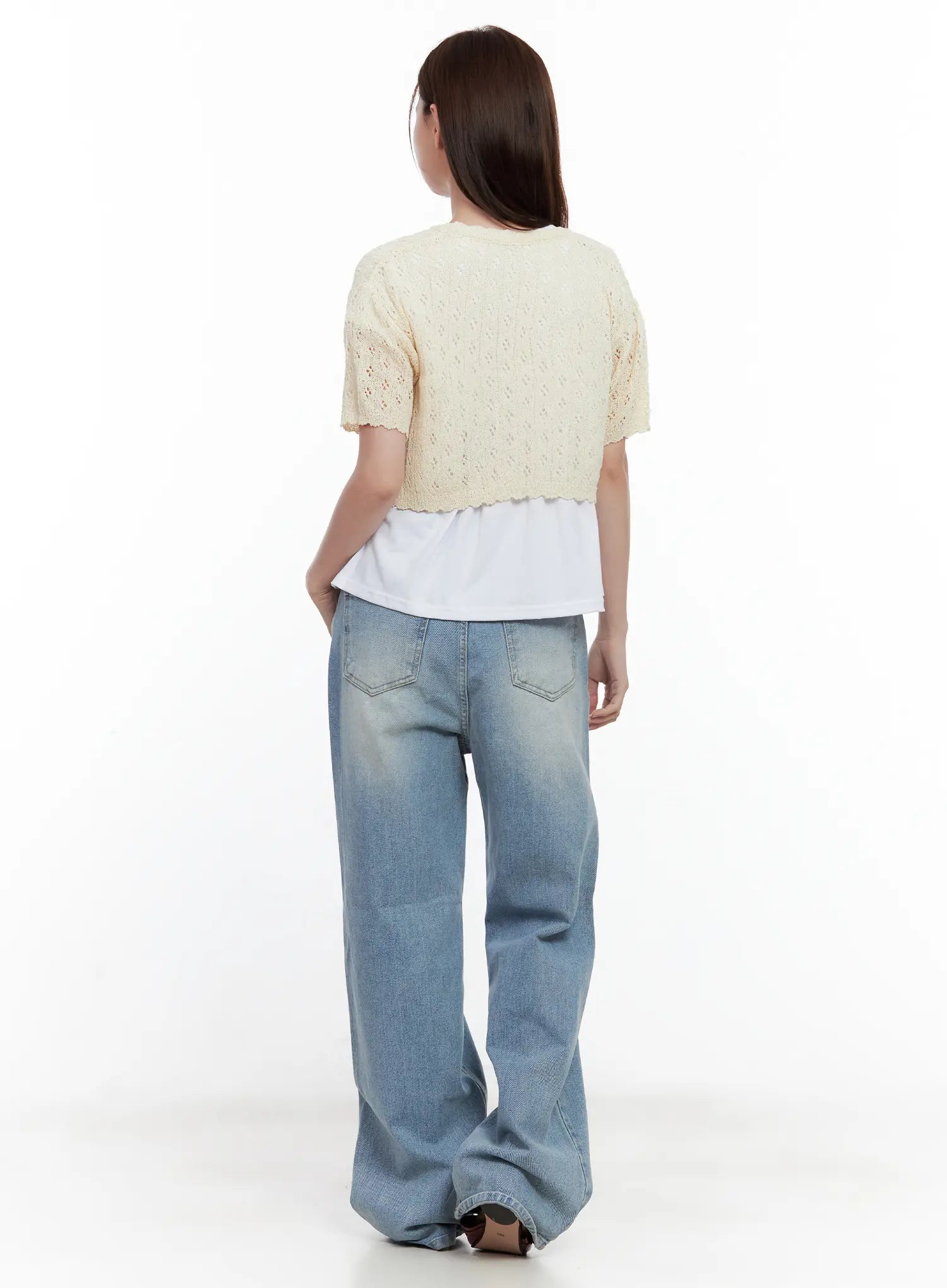 Ina Slouchy Fit Jeans CL502 in blue, back view on model, washed denim with back patch pockets and subtle fading, wide slouchy leg, styled with cream crochet shrug and white top.