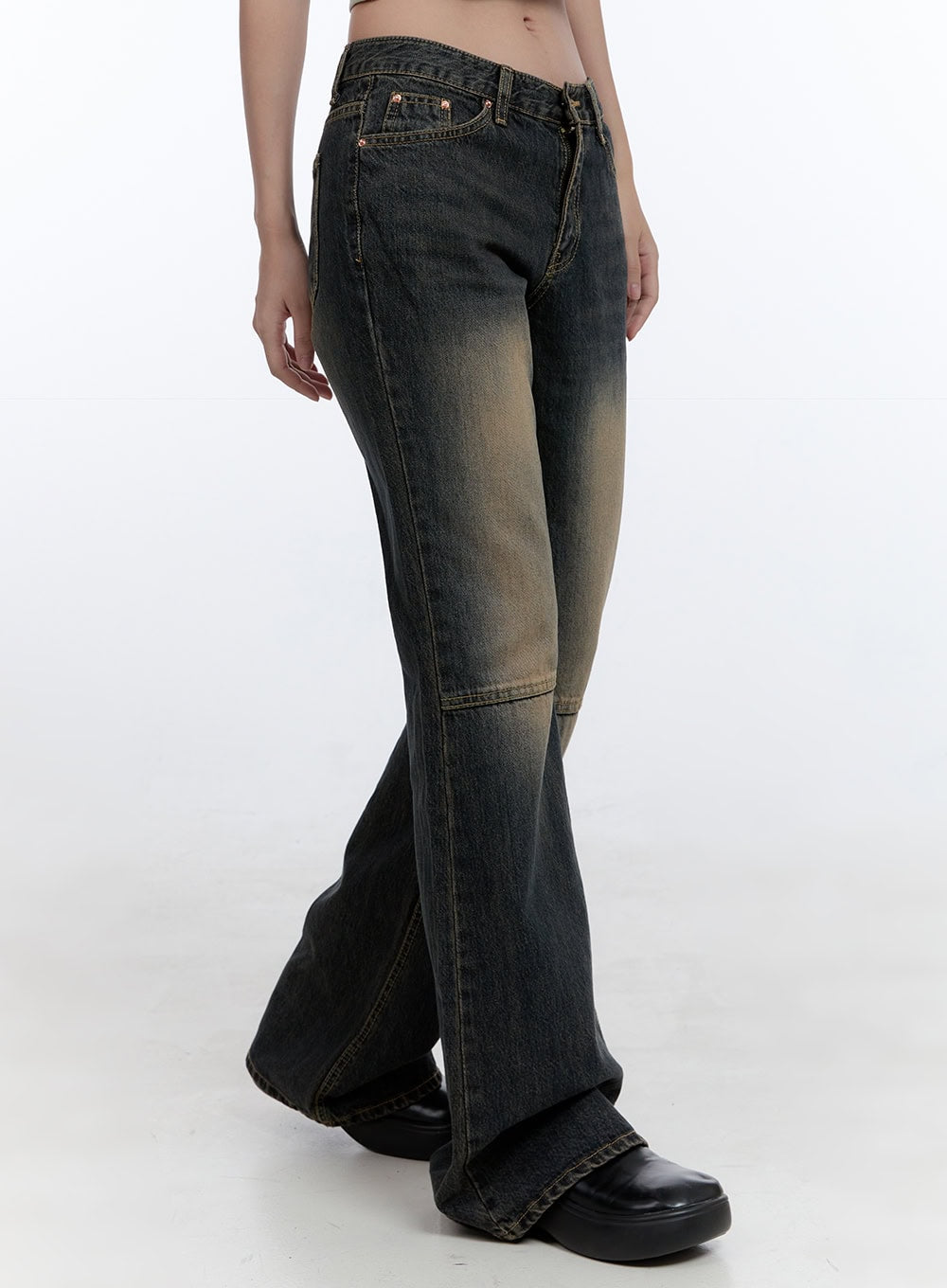 Kira Stitched Detail Bootcut Jeans CG414 in dark blue, side view on model, low-waist slim fit with washed amber fade, horizontal knee stitch panel, bootcut flare at ankle, black platform loafers.