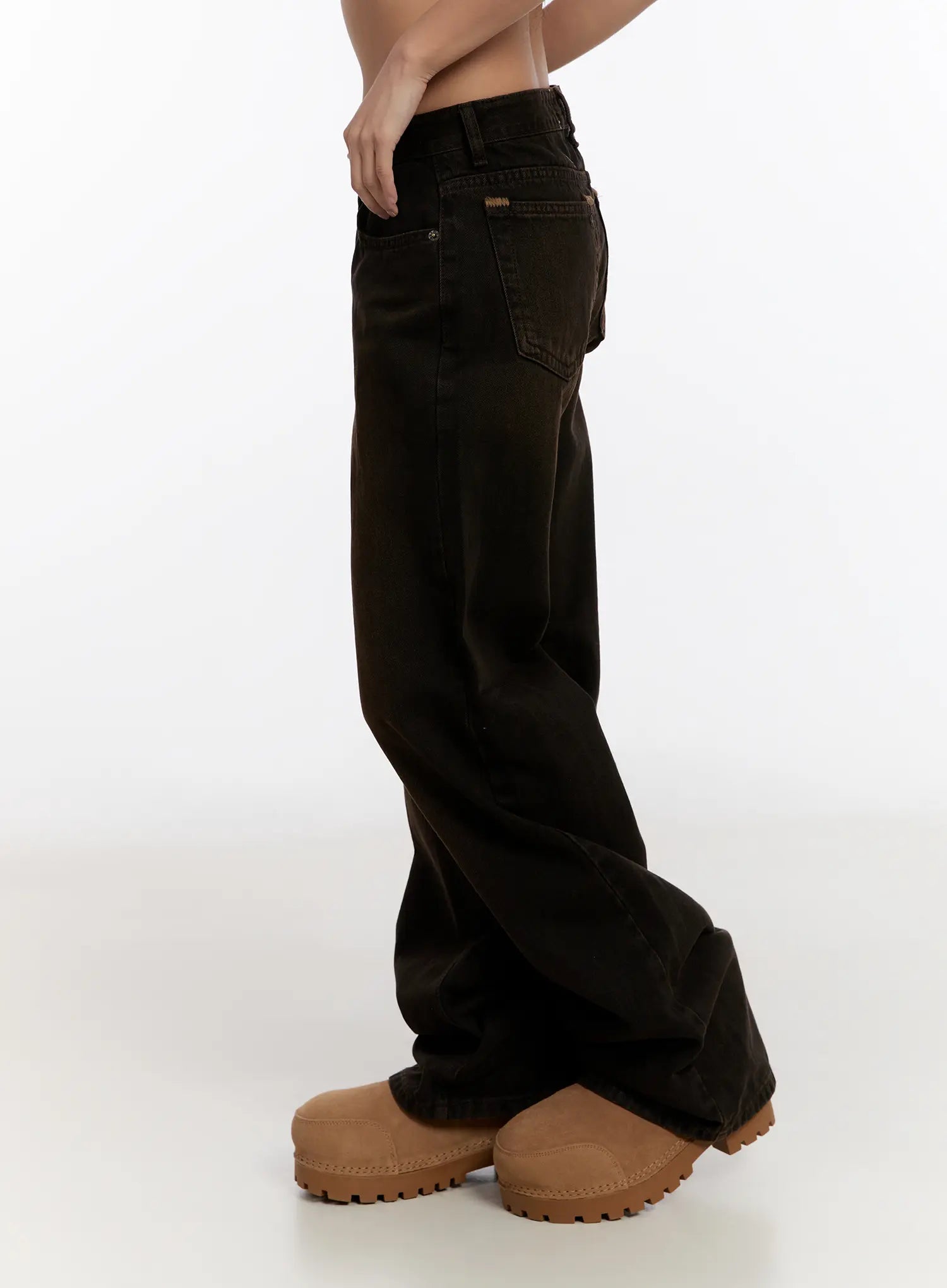 Mael Low Rise Straight Jeans CN527 in black, side view on model, showing low-rise fit, straight leg silhouette, back pocket, and full length pooling over tan chunky clogs.