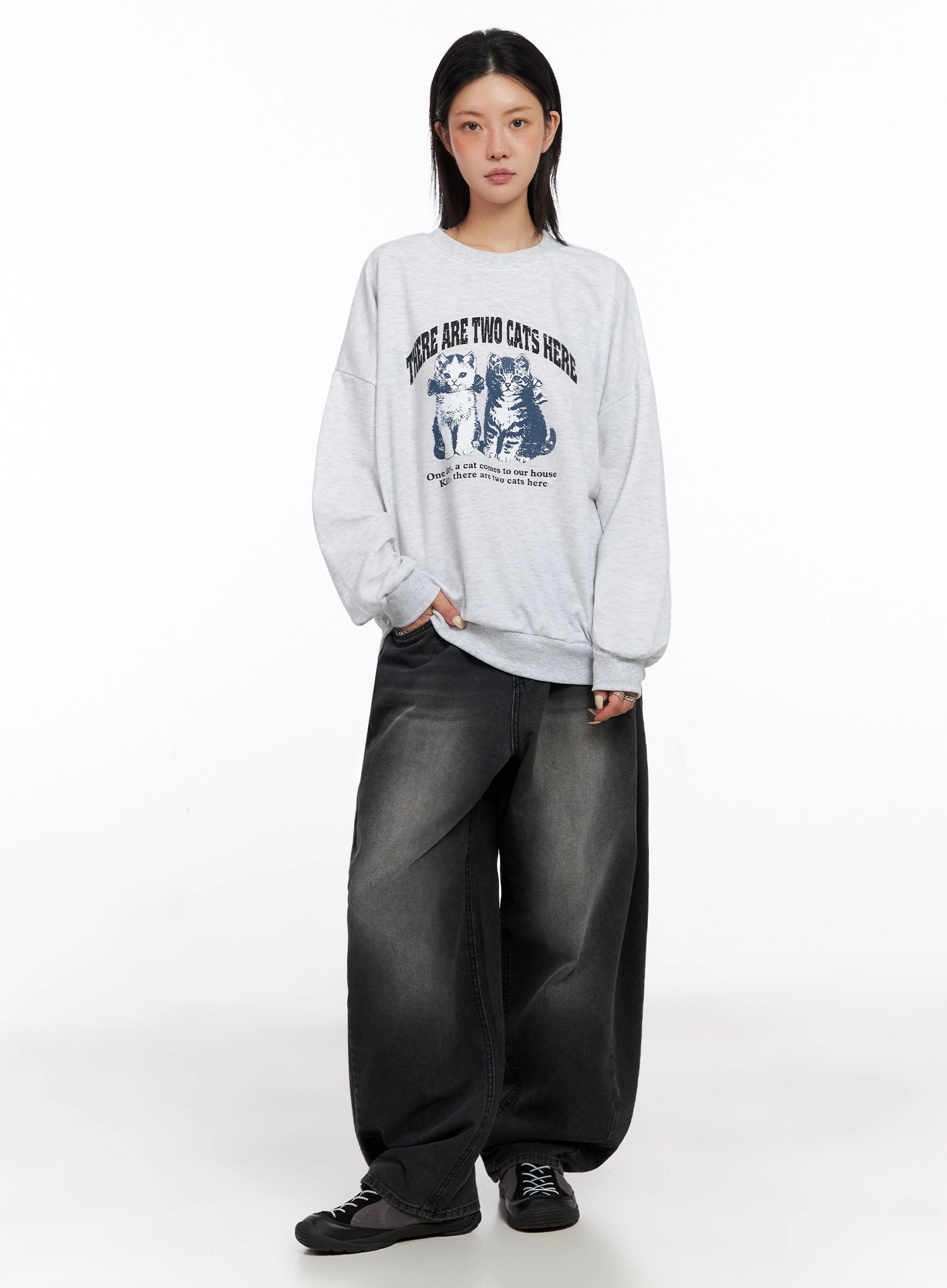 Ayra Dark Washed Baggy Jeans IS508 in dark grey, full-length front view on model, oversized baggy fit with washed cotton denim, paired with grey cat graphic crewneck sweatshirt and black sneakers.
