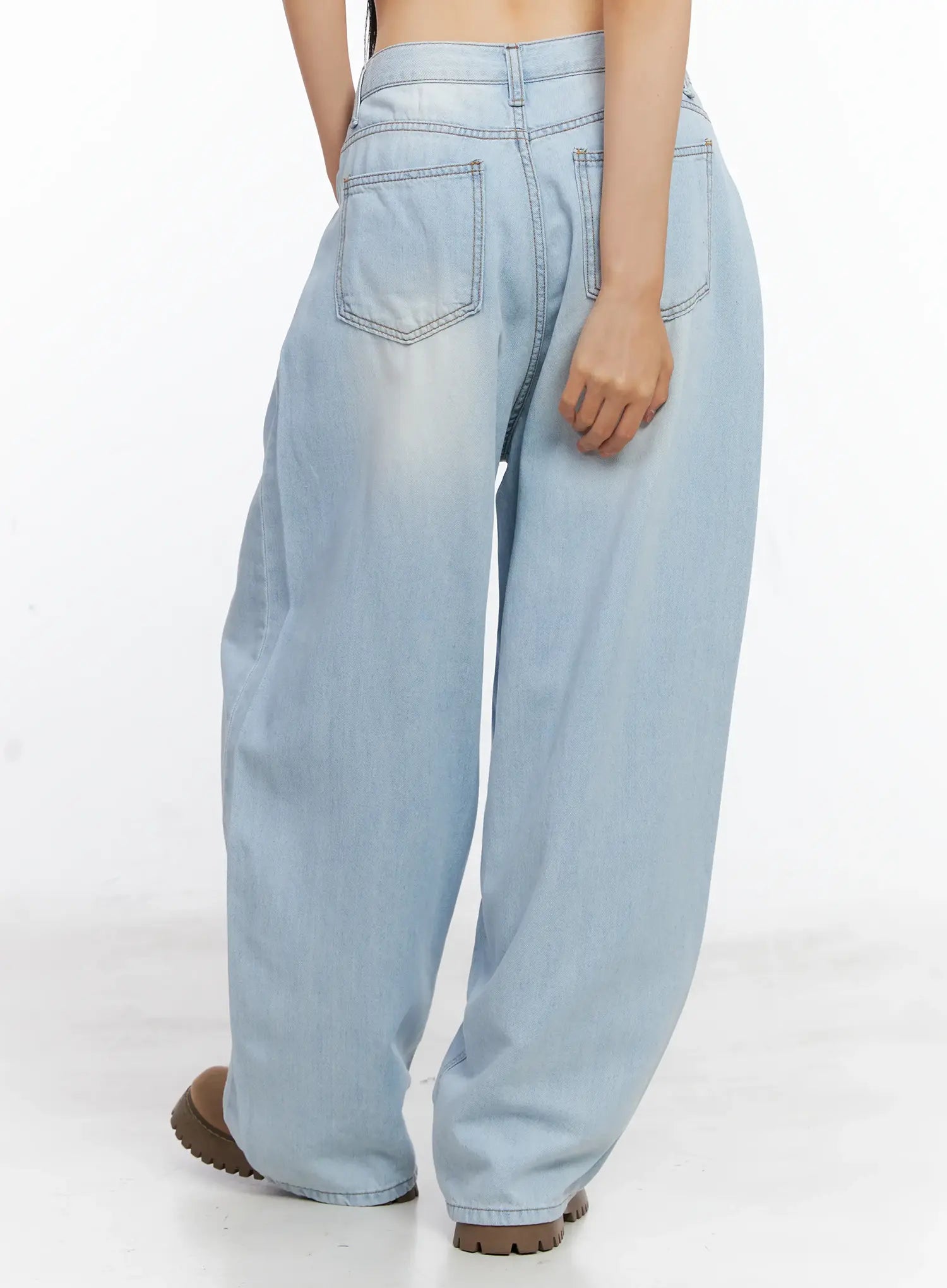 Bona Relaxed-Fit Denim Jeans CL529 in light blue, back view waist-to-hem on model, showing patch back pockets with contrast stitching, washed finish, and wide-leg drape over chunky boots.