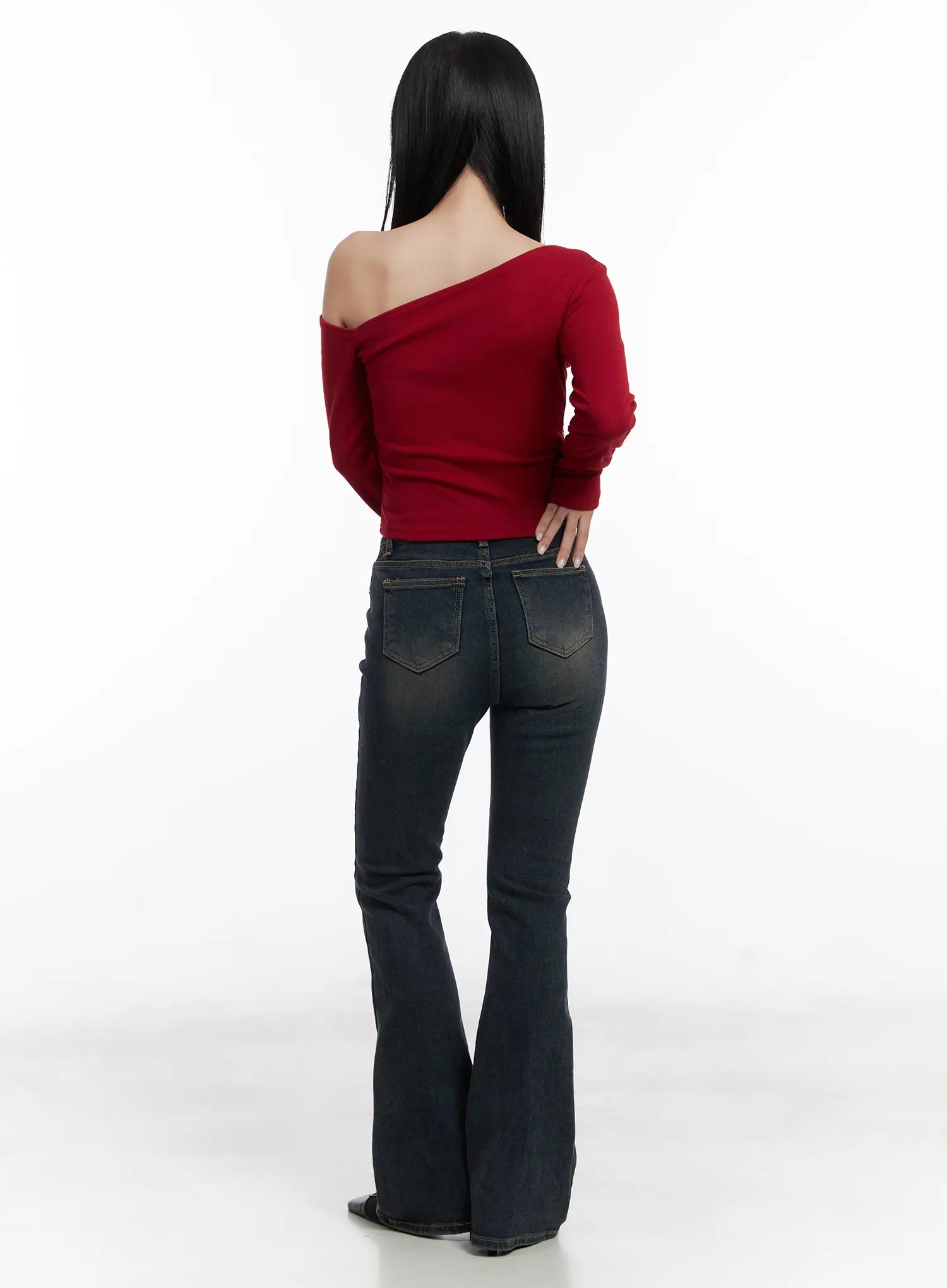 Jay Dark-Wash Bootcut Jeans CD501 in dark blue, back full-body view on model, dual back pockets with gold stitching, fitted seat and flared bootcut hem, paired with red off-shoulder top.