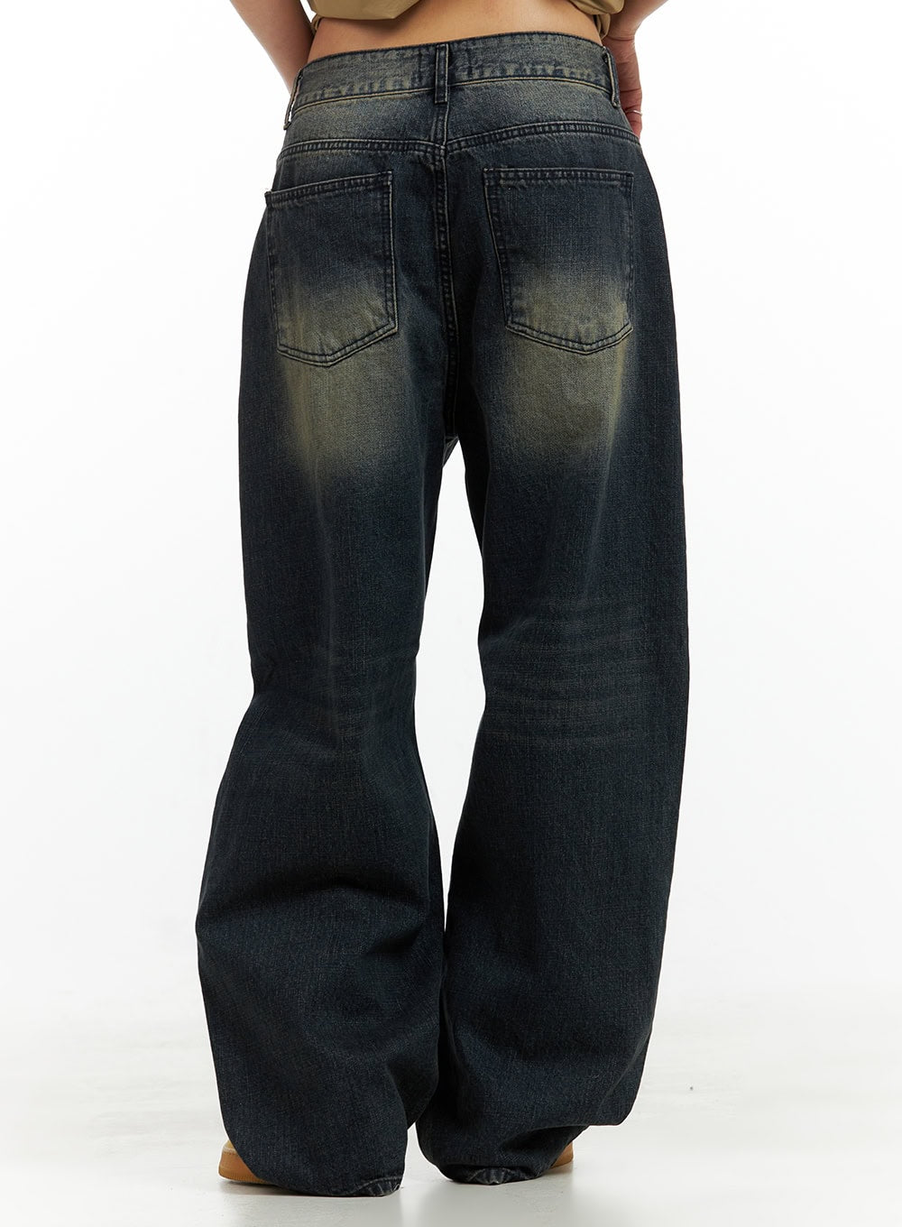 Solid Low Rise Baggy Jeans CU417 in dark blue, back view close-up on model, washed cotton denim showing dual back pockets with yellow fade detail and voluminous wide leg silhouette.
