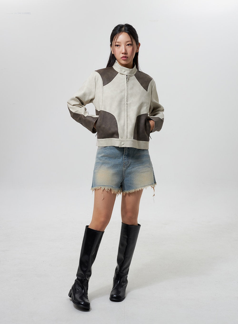 Mid-Rise Ripped Jeans CY323 in light blue, full-body front on model hands on hips, washed short denim with frayed hem, layered under patchwork jacket with black knee-high boots.