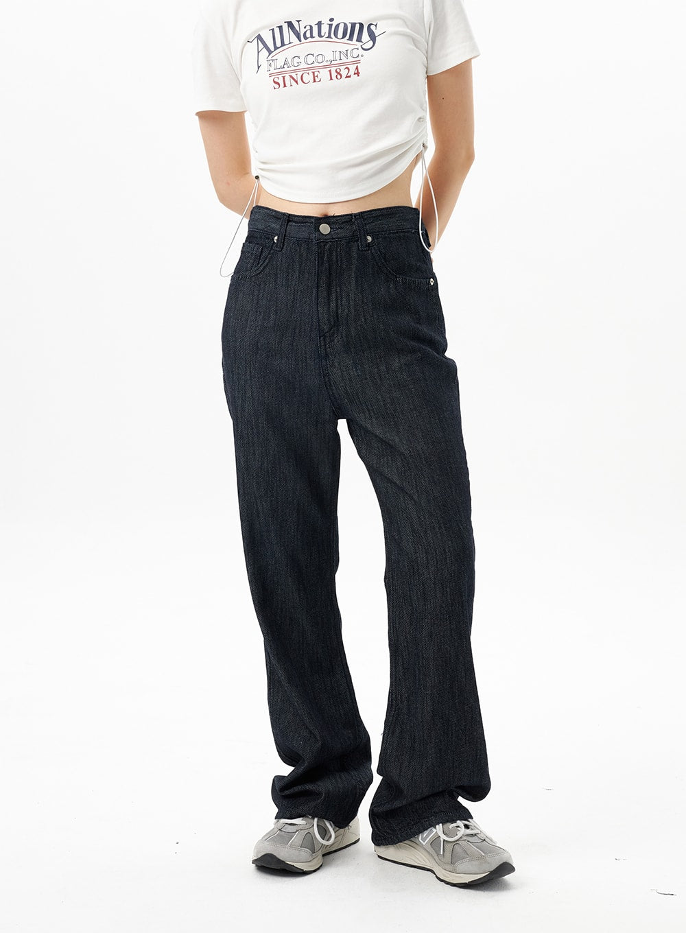 Dark Wash Mid-Rise Jeans OU314 in dark blue, waist-to-hem front close-up on model, mid-rise waistband with silver button, front pockets and textured denim fabric detail.