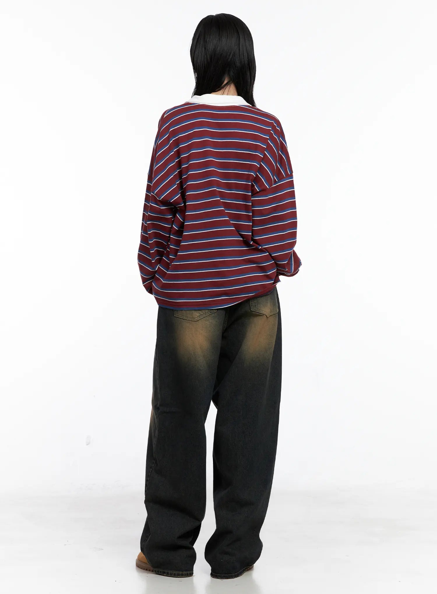 Leona Vintage Baggy Jeans CS526 in dark blue, back view on model, full-length wide-leg denim with amber vintage wash, paired with striped rugby top and tan boots.