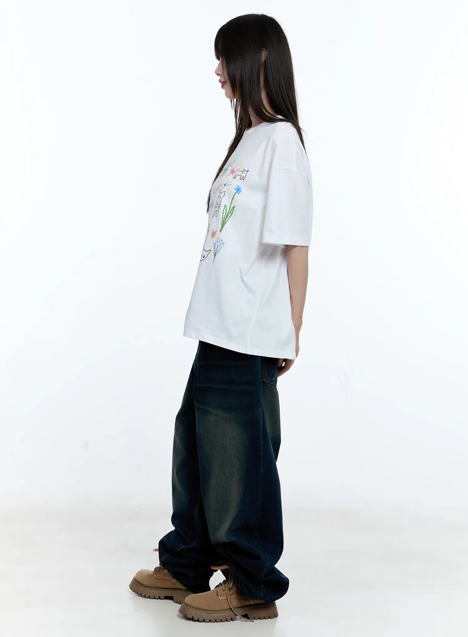 Jinnie Washed Wide-Leg Jeans CG511 in dark blue, full side view on model, showing wide-leg silhouette length and washed denim gradient, styled with white graphic tee and tan chunky boots.