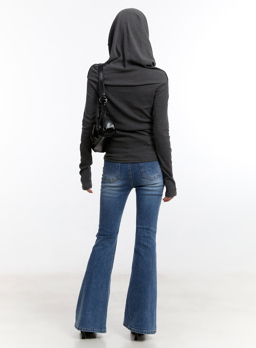 Maris Hip-Pad Bootcut Jeans CA508 in blue, back full-body view on model, washed denim with back pockets and hip-pad detail, bootcut flare, paired with grey hoodie and black bag.