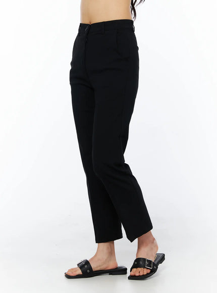 Hip-Pad Capri Pants CU522 in black, side view on model, showing tailored straight-leg capri length, side pocket seam and zip closure detail, with buckle sandals.