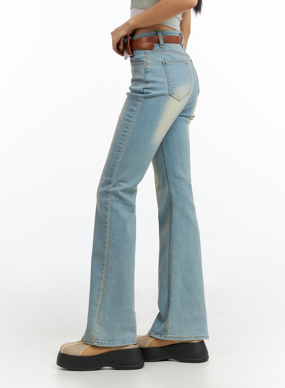 Light Washed Slim Fit Bootcut Jeans IL409 in light blue, side close-up on model, showing slim thigh fit, subtle washed fading, and flared bootcut hem with contrast stitching.