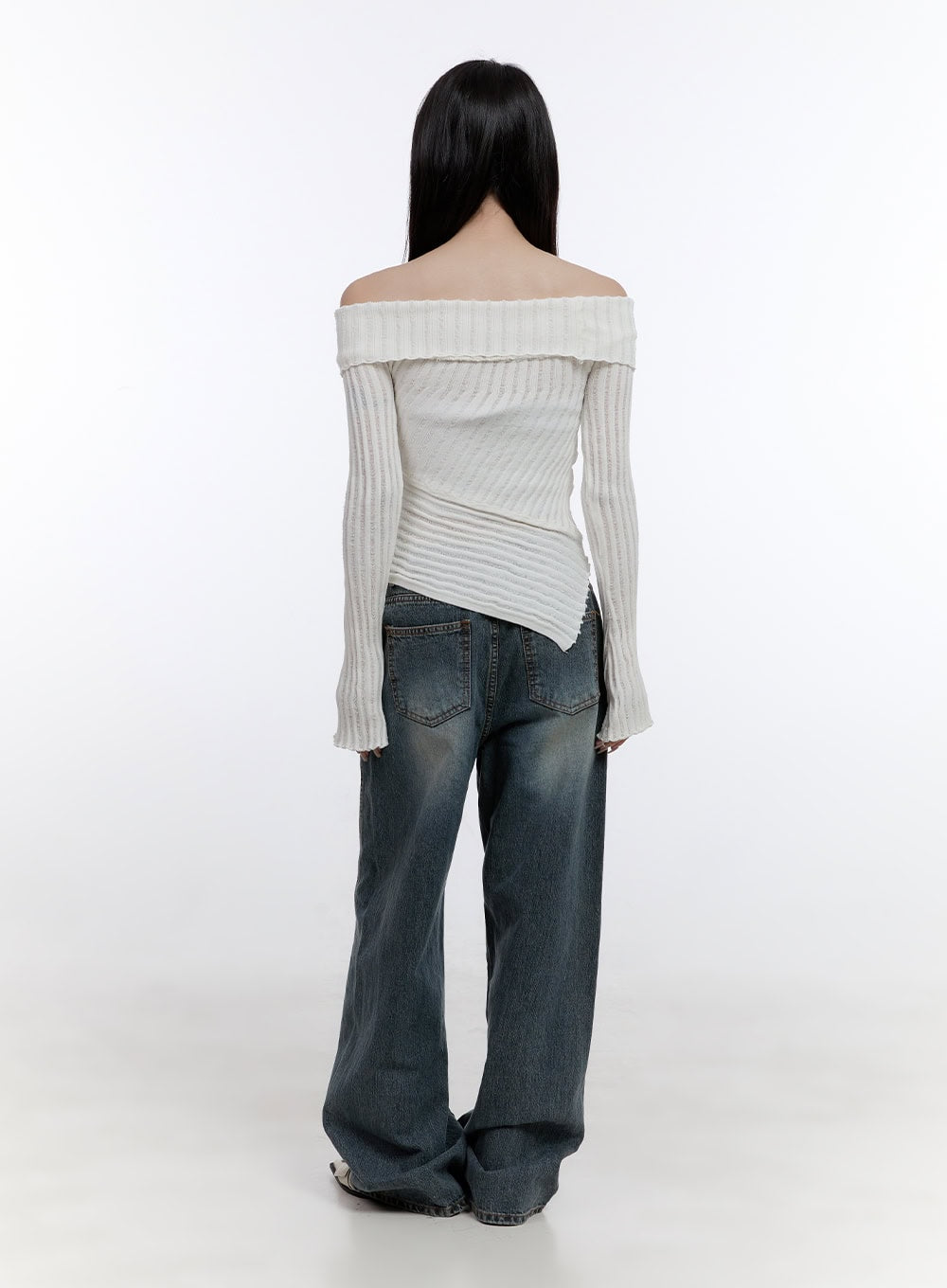 Lucia Stitched Denim Baggy Jeans CO418 in blue, back full-body view on model, revealing two back pockets with contrast stitching and washed denim finish, styled with asymmetric cream knit.