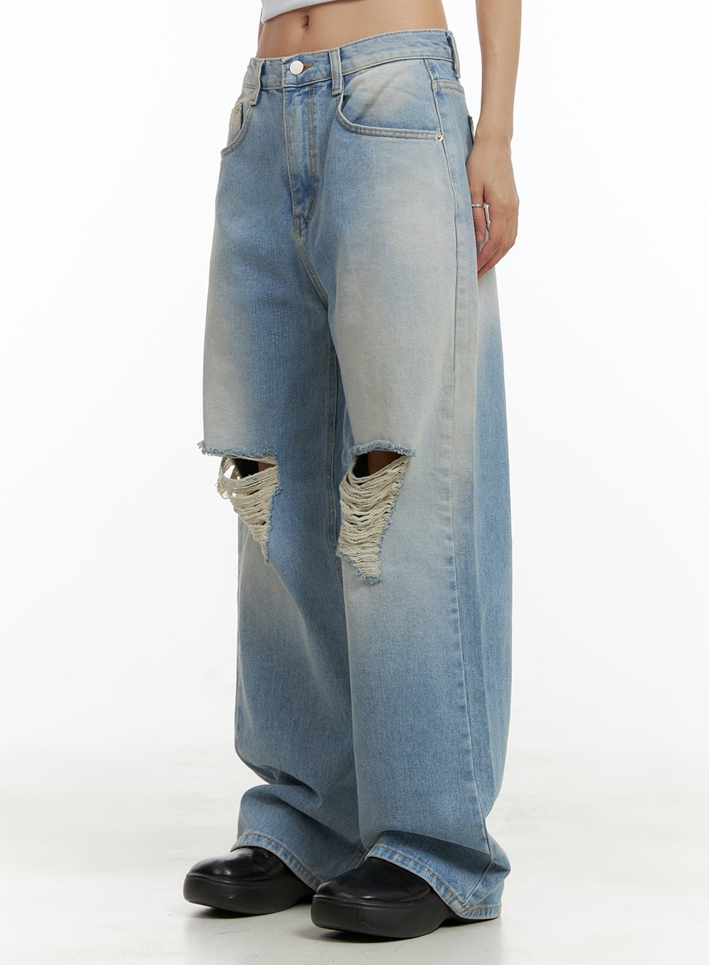 Urban Washed Ripped Baggy Jeans CU405 in Blue, side angle waist-to-hem on model, highlighting wide baggy leg, washed fading gradient, and large frayed knee rip on left leg.