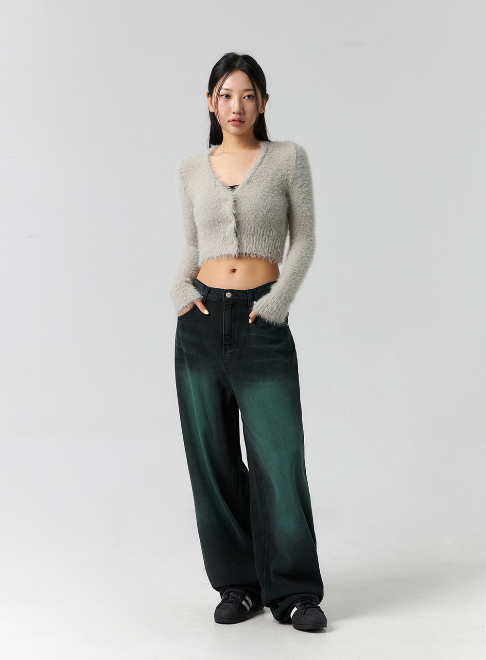 Comfy Wide Leg Color Jeans CS305 in dark green, full-length front shot on model with hands in pockets, wide-fit faded denim, paired with grey fluffy crop cardigan and black sneakers.