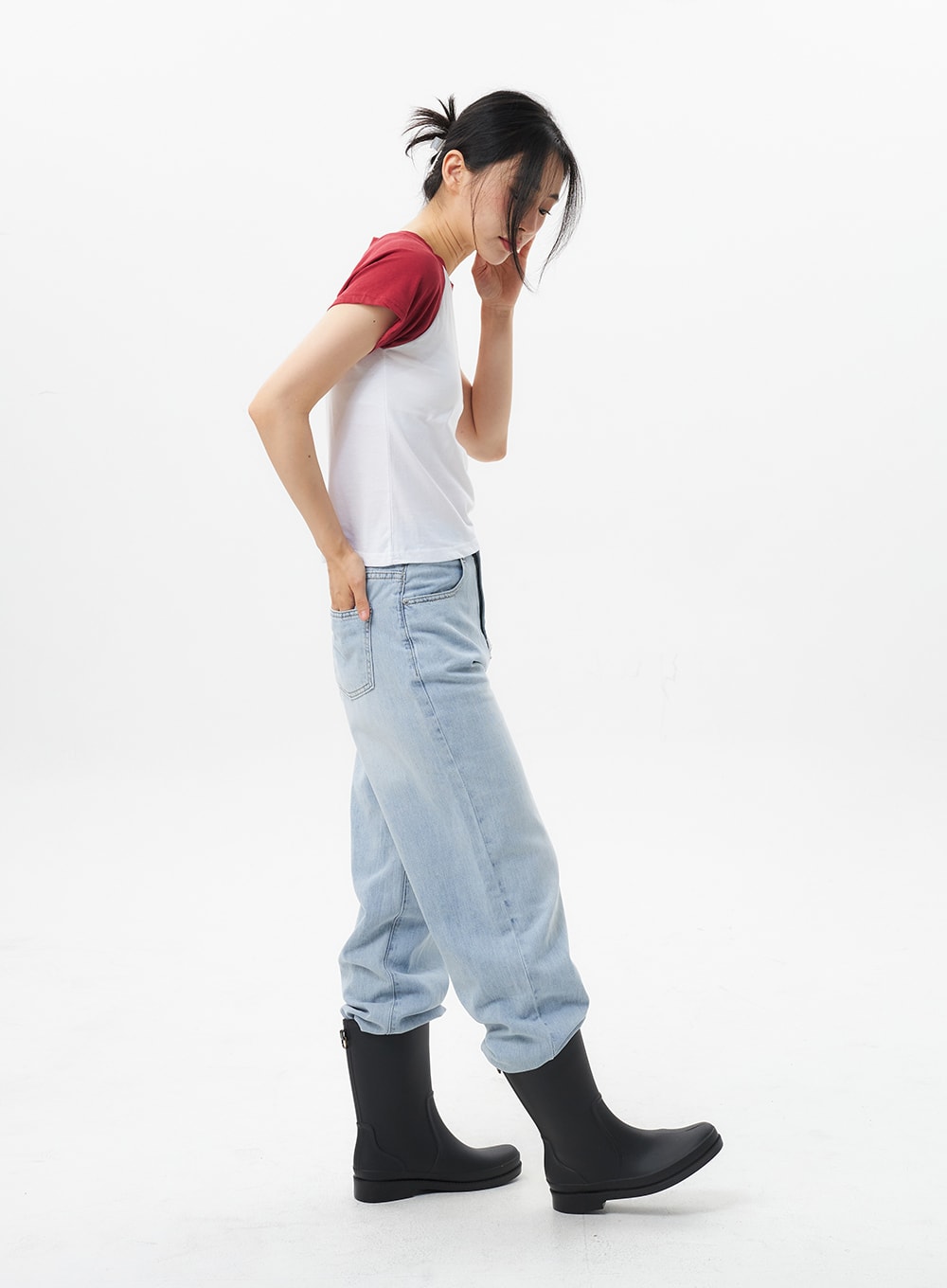 Wide Straight Leg Jeans OL304 in light blue, side profile shot on model mid-stride, wide-leg cotton denim with soft faded wash, hem pooling over black rain boots.