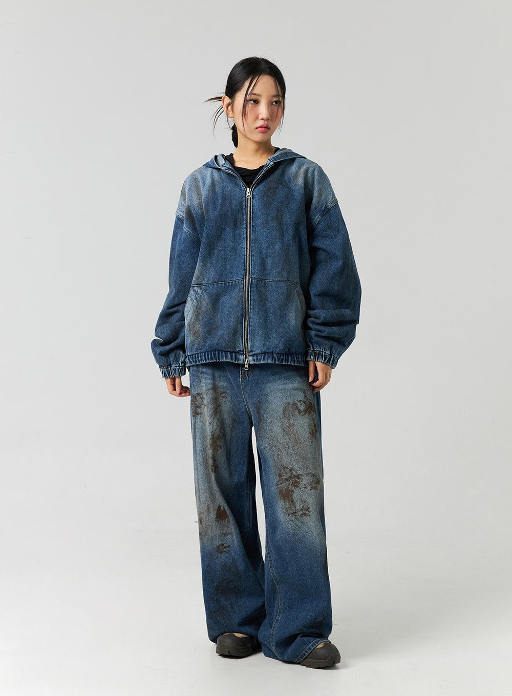 Street-Style Wide Fit Washed Jeans CO323 in Blue, full-body front on model styled with zipped denim hoodie, relaxed wide leg silhouette with heavy brown washed pattern on cotton denim.