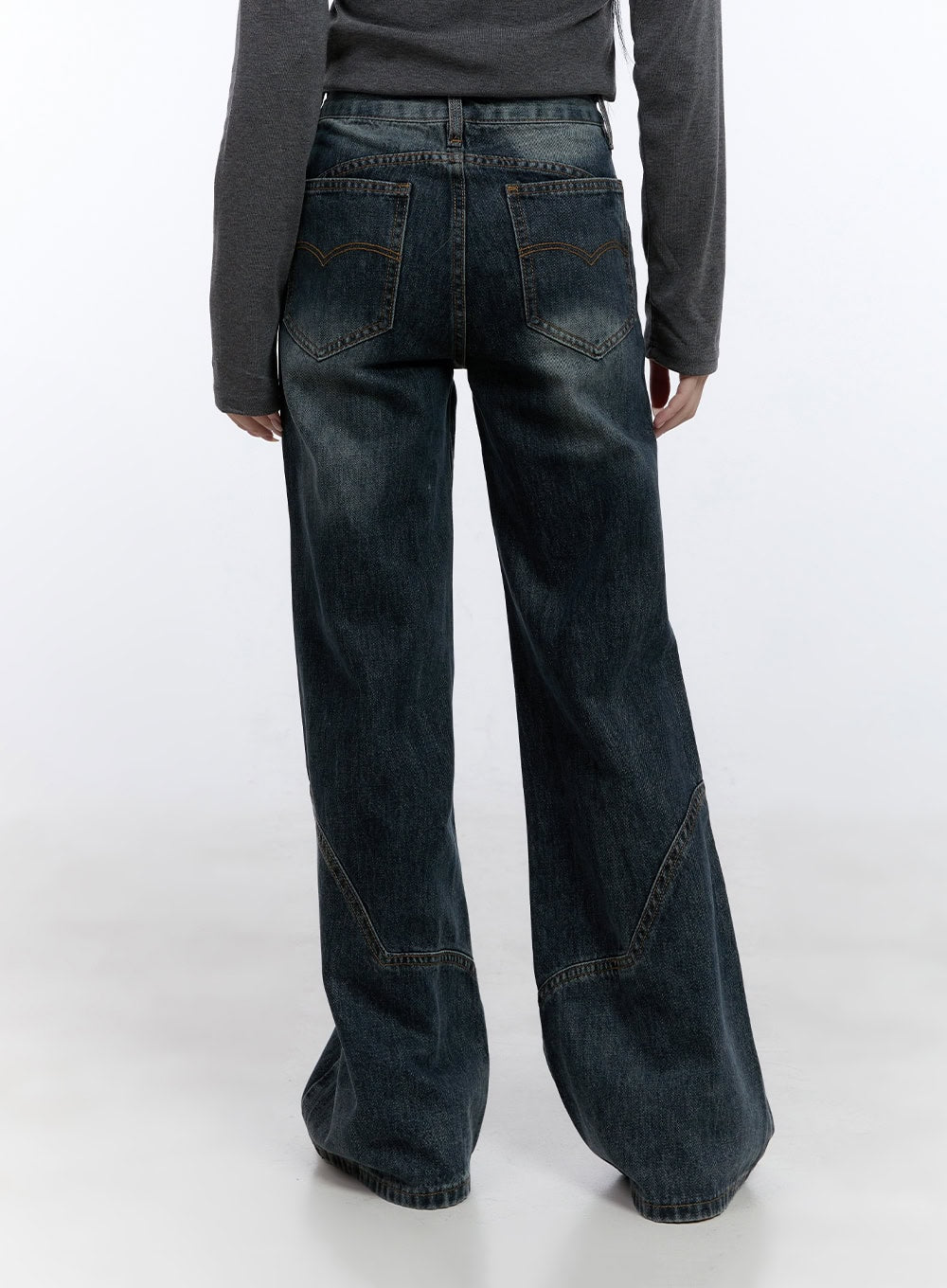 Barbara Washed Wide Leg Jeans CD420 in blue, back cropped view on model, washed denim with decorative back pockets and contrast orange stitching, curved hem panel detail, paired with grey long sleeve top.
