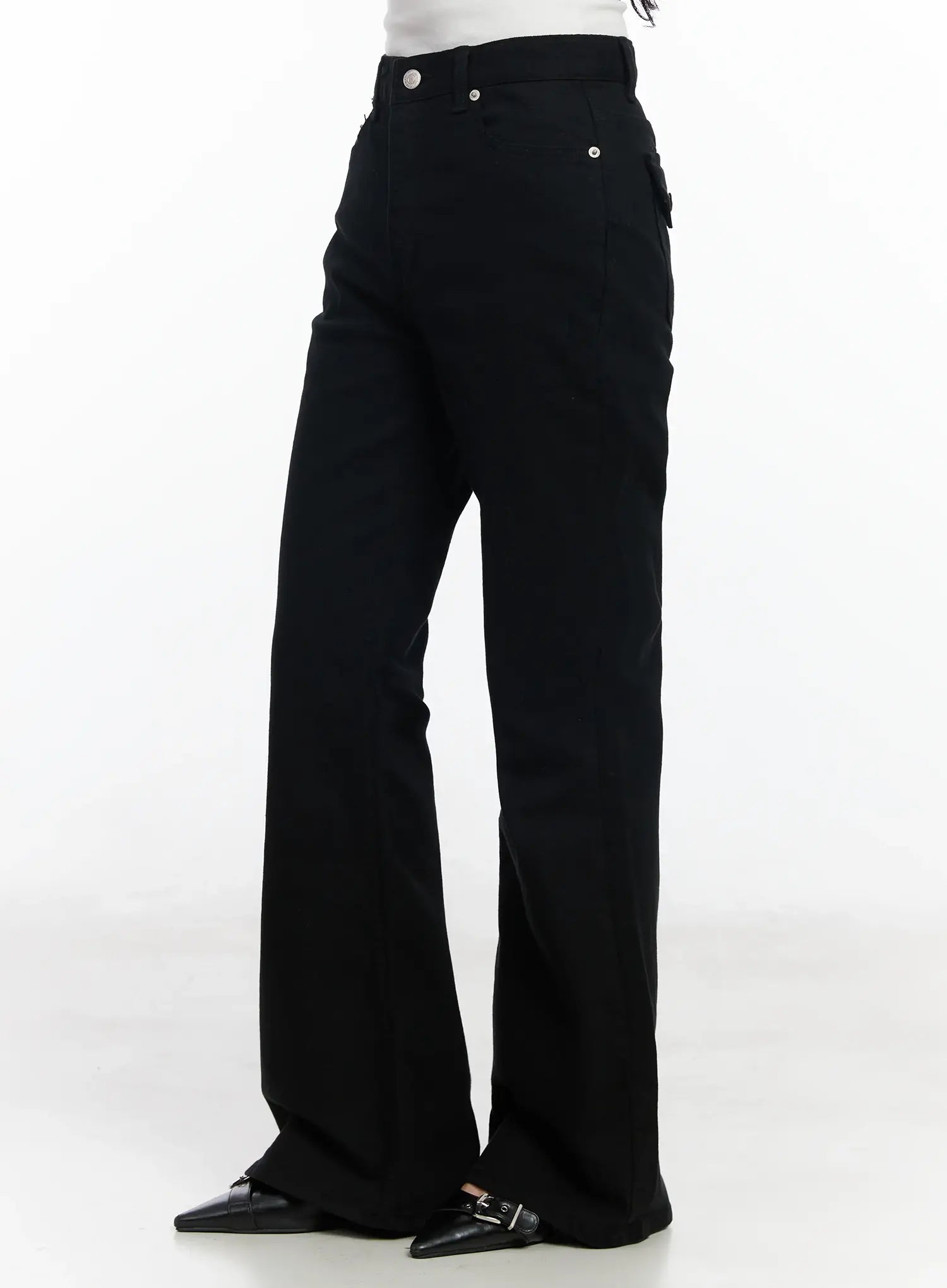 Ellis High-Waist Bootcut Jeans IJ529 in black, side-angle product shot on model, showing high-rise waist, slim thigh, and gradual bootcut flare, with side pocket detail and black buckle mules.