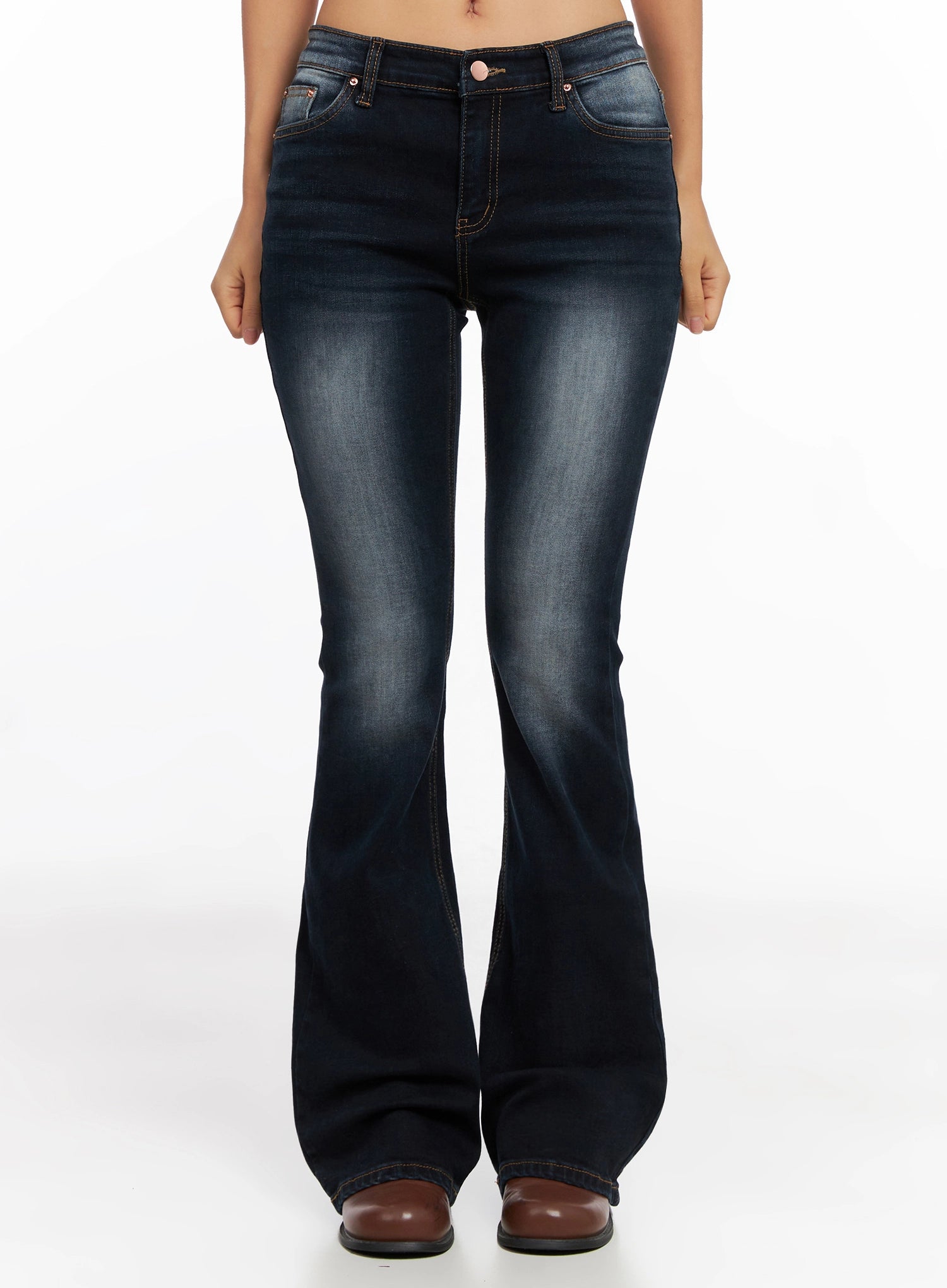 Aliyah Mid-Rise Hip Pad Flared Jeans IG528 in dark blue, front full-length no-top shot on model, hip pad silhouette and flared bootcut leg shown, contrast stitching detail, brown boots.